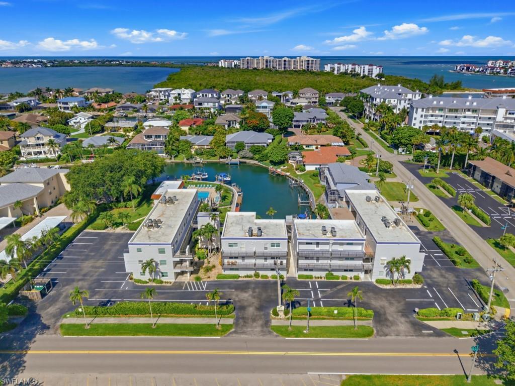 Welcome to this charming 2 bedroom, 1 and a half bath end residence offering island-style waterfront living. The open and inviting layout provides a great space for everyday living, while the first-floor location offers easy access with no stairs.  This lovely residence offers the added convenience of in-residence washer and dryer.  Enjoy quick, direct Gulf access within minutes from the common docks. Model Village is a low density building and offers beautiful community pool, grill, and spacious deck where you can enjoy picturesque sunsets. With a 1 night minimum rental policy, this gorgeous residence has endless rental potential. Many popular restaurants, the Shops of Olde Marco, marinas, and more are all at your fingertips.  Whether you're looking for a full-time residence, seasonal getaway, or investment opportunity – this residence is ready to welcome you home.