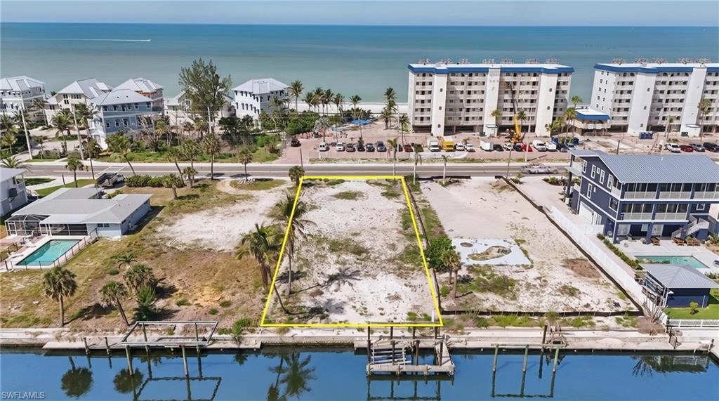 GULF VIEWS IN THE FRONT, BEAUTIFUL SUNRISES IN THE BACK, and 14,919 SQUARE FEET OF OPPORTUNITY IN BETWEEN! Discover an exceptional waterfront homesite DIRECTLY across from the Gulf at 5157 Estero Blvd, Fort Myers Beach. Build to suit or bring your own builder and design the home that belongs on this shoreline. With an existing seawall and navigable canal access, this expansive parcel offers the freedom to envision a custom coastal residence complete with a resort-style pool, generous outdoor entertaining spaces, and tropical landscaping. Spend your mornings strolling the beach, afternoons exploring Southwest Florida’s waterways, and evenings enjoying breathtaking Gulf sunsets. Conveniently located near island restaurants, beach cafés, and waterfront dining, this distinctive property offers an extraordinary canvas for your vision of coastal living.
