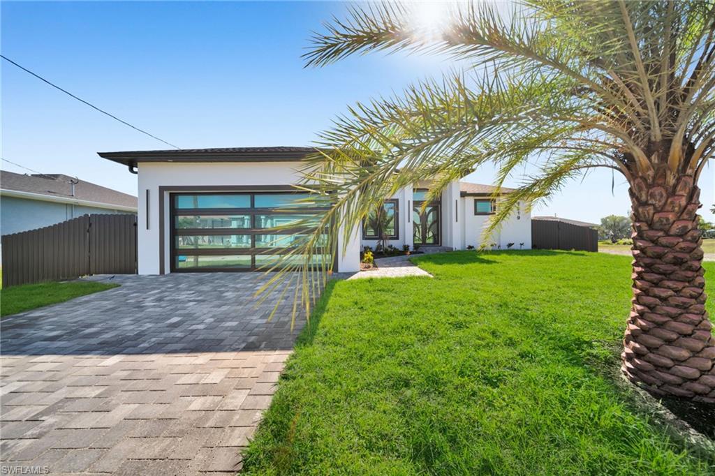 Step into modern Florida luxury in this brand-new 2026-built Sapphire model, offering 1,910 sq ft of refined living, 4 bedrooms and 3 baths with a sleek, contemporary feel throughout. An expansive great room with soaring tray ceilings, full-home polished porcelain “marble” tile, and a dramatic wood-slat feature wall with book-matched slab detail creates a stunning first impression. The chef’s kitchen is the heart of the home, showcasing a large waterfall island, white shaker cabinetry, quartz counters and backsplash, walk-in pantry, premium stainless appliances, and bold gold hardware illuminated by sculptural LED pendants. Corner and triple sliders stack completely to blend indoor and outdoor living, opening to a pavered lanai, outdoor kitchen with grill and fridge, and a sparkling pool for effortless entertaining. The split plan primary suite features a tray ceiling, generous walk-in closet, and spa-inspired bath with double vanities and an oversized walk-in shower, while guest rooms enjoy a stylish bath that doubles as a pool bath. Additional upgrades include impact-rated windows and doors built to 2023 Florida Building Code, tall interior doors, designer fans and lighting, dedicated laundry room, and an oversized 2-car garage, all in a clean, modern package that feels like a boutique resort the moment you walk in.