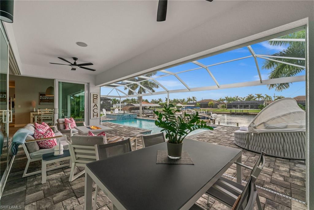 MODERN - GULF ACCESS - EXTRA WIDE CANAL - WESTERN EXPOSURE

Picture this, morning coffee on your front porch with an unobstructed sunrise view stretching the full length of the street right to your driveway, and evenings unwinding poolside as the sun sets in a blaze of color over your own extra wide canal. Set at the end of the street, this amazing lot gives you breathtaking water views out back, and with only 30 minutes separating your dock from the open waters of the Gulf, it's a lifestyle built for the water lover who wants room to breathe.

Built in 2018 and thoughtfully extended in 2023, this home now offers 4 bedrooms, 3 bathrooms and a versatile den, giving your family and guests the space to truly spread out and live. Hurricane impact windows throughout mean peace of mind no matter the season.

Car and boat enthusiasts will love the three car garage, with the third bay cleverly separated by its own wall and cooled by a private mini split AC unit, perfect for a workshop, gym, or extra storage that stays comfortable year round.

Step outside to your private oasis, a heated saltwater pool made for year round swimming, and a 10,000 pound boat lift ready for your next adventure on the water. Electric shutters on the lanai let you close everything up in seconds, whether it's for storm season or simply a lazy afternoon in the shade. New garage doors add the finishing touch to a home where every detail has been considered.

Western exposure means unforgettable sunsets over the water every single evening, while your end-of-street position delivers a front row seat to sunrise each morning. This is Southwest Florida waterfront living at its best.