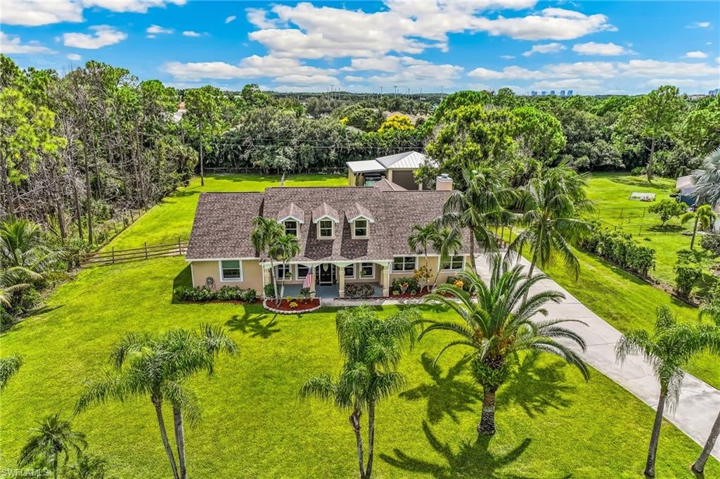 RARELY AVAILABLE IN ESTERO, THIS IS A MUST SEE - SPECIAL POOL HOME SITUATED ON 1.10 ACRES BOASTING BOTH DETACHED 2-VEHICLE/BOAT GARAGE & CARPORT (RV) AND AN OVERSIZED ATTACHED TWO-CAR GARAGE. THIS UNIQUE PROPERTY IS LOCATED IN THE THRIVING VILLAGE OF ESTERO LOCATED WEST OF I-75, OFF CORKSCREW & RIVER RANCH RD. ENJOY A LOVELY NON-RESTRICTIVE NEIGHBORHOOD WITH NO HOA FEES, NO RULES FOR VEHICLES/PETS - LIVE LIFE YOUR WAY! Residents enjoy country-style living in their custom-built homes on a peaceful street while being close to anything you need/want! The warm feelings begin as you drive up to this well-maintained property & home - large front yard with a variety of palm trees, colorful landscaping with pavers, lengthy driveway for a large family & guests! PLUS a Detached Garage w/ 13'6" high, 12'9" wide doors & a carport and a big back yard! Time to go inside.  As you get to the front door & foresee layout options, view the stunning cypress wood ceiling w/custom lighting! Welcome to this spotless home for your tour now. The den/office is impressive w/double French doors & tile plank flooring. For family dinners & holidays, the spacious formal dining area will accommodate many guests! Cozy front living area ideal for quiet time while looking out onto the lanai/pool. Adjacent is the Primary bedroom - tile plank flooring, French doors to lanai, closet with cabinets! Bath w/separate tub & shower, dual sinks, make-up table! Open kitchen w/ stainless steel appliances, granite counter-tops, a pass-through window to lanai & new backsplash! Large family room wired for speakers, ceramic tile, wood-burning fireplace w/bench & mantle, planter shelves.  Second & Third bedrooms - tile plank flooring, walk-in closets, faux wood blinds.  Carpeted, 2nd floor Bonus Room (14'x 28') w/ 3 dormer windows with access doors from garage & formal dining area! Oversized 2-car attached garage with new epoxy floor, PLUS a detached Garage featuring two bays w/ 13'6" high doors with drive-through access that will entice owners of Boats, RVs, recreational vehicles, etc.  The Pool area has brick pavers, cypress wood ceiling, galvanized fence & enticing pool with nautical mosaics. Fenced in dog-run! Recent Improvements: Cypress Wood Ceilings on Lanai & Front Porch Refinished, Painted Front Porch, Garage Floor Epoxied, Interior Painted Walls July 2026, Shingle Roof 2023, Hot Water Heater 2026, Pool Pump April 2026, Two Air Conditioners 2021, Garage Door & Trim Painted 2026, Well Pump & Pressure Tank 2024, Septic Serviced 2024, SS Appliances 2023.  Walking distance to Estero Recreation Center featuring outdoor concerts, festivals, indoor & outdoor pickleball, soccer fields, playgrounds, and even serves as a hurricane shelter when needed. Just minutes to I-75 and/or US 41, Fort Myers International Airport and of course, plentiful amount of shopping and dining options.  Descriptions under photos!