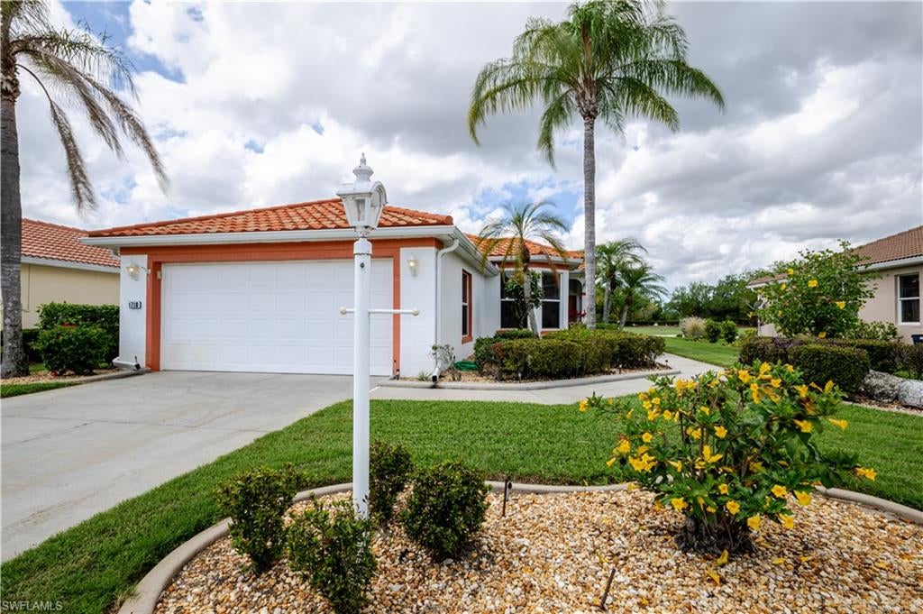 Looking for a home with quick and easy access in and out of beautiful Herons Glen… then this is the one for you. This unique layout balances function with flow and is designed for ease, connecting everyday living to both the landscape and the community rhythm. Walk up to the side entrance and step into this two-bedroom two bath home with thoughtful upgrades. Screened in front loggia, freshly painted throughout the inside, new luxury vinyl plank flooring in the bedrooms, all new fans and light fixtures along with new electrical outlets and switches throughout. 2021 new metal roof and accordion hurricane shutters in the back screened in lanai.  Sweeping golf course views that create a setting that is both active and calm. This homes comes turnkey with a golf cart included and is waiting for it's new owner to start living the Florida dream. Herons Glen voted one of the safest communities boasts a brand new championship 18 hole golf course(voted 2nd best golf course in Florida), 6 Har-Tru lighted tennis courts, pickleball courts, brand new state-of-the-art fitness center, bocce, shuffleboard, resort style pool/spa, and a fabulous new bar and restaurant!