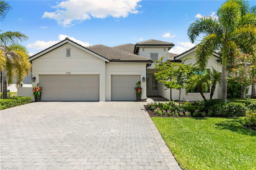 Welcome to this exceptional Lennar Summerville model, offering 3 bedrooms plus an office, 3 bathrooms, and a spacious 3-car garage, thoughtfully designed for refined living and everyday comfort. From the moment you enter, the home reveals a sense of luxury with intentional upgrades throughout including impact-resistant windows and doors throughout, a whole-home generator, tankless water heater, Tesla EV charging station, insulated garage doors, and a fully equipped garage workshop with cabinetry and 4 large overhead storage shelves. The heart of the home is the expansive great room, anchored by a striking statement wall with integrated backlighting and tile detail, casting a warm ambient glow that elevates the entire space. The kitchen is designed for both style and convenience, featuring quartz countertops, a gas cooktop, stainless-steel appliances, upgraded cabinetry with pull-out drawers, refined lighting enhancements including dynamic pendant lighting over the island and a stunning chandelier in the dining room, and a layout that seamlessly connects to the main living areas for effortless entertaining. The professional office is enhanced with custom built-in cabinetry on both sides allowing for two work stations, large enough for dual monitors and further equipped with back-up batteries providing uniterrupted service of Starlink and Xfinity services. Ambient accent lighting above and below the cabinetry in the office creates an ideal work-from-home environment that is both functional and elegant. The private primary suite serves as a serene retreat equipped with automatic privacy shades and a spa-inspired bathroom offering a euro-glass shower, bidet, two large medicine cabinets conveniently located behind the entry door and the water closet door, and two spacious custom walk-in closets providing exceptional organization and a boutique-like experience. The lanai is highlighted by a resort-style pool and infinty-edge spa, outdoor gas kitchen, sunshelf and gorgeous golf course views creating a private oasis perfect for relaxing or entertaining. Blending sophistication, thoughtful upgrades, and modern efficiency, this residence offers a truly elevated lifestyle in a home that is as functional as it is beautiful. The award-winning, resort style community of Fiddler's Creek is enhanced by a club and spa, fitness center, swimming pools, two golf courses, tennis courts, pickleball courts, a bocce court, fine and casual dining, social activities, and miles of biking and walking paths. Optional beach club and marina memberships are available. Experience the epitome of luxury living, where every detail is thoughtfully curated to complement your lifestyle.