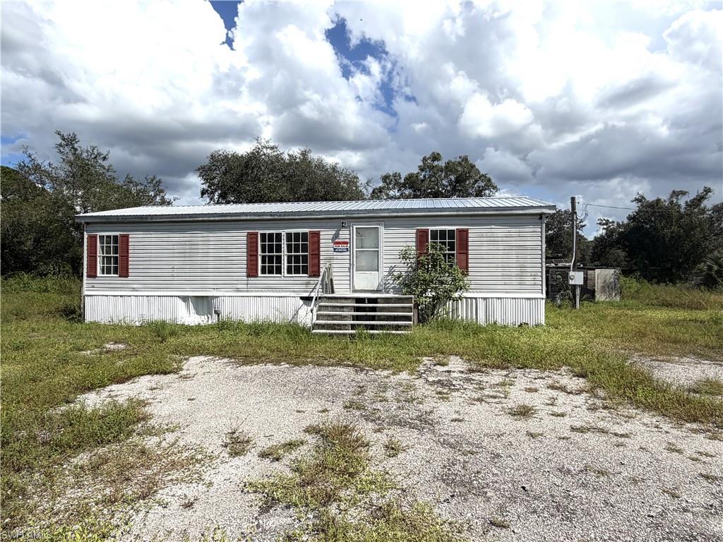 1.26acre fenced in for sale in Montura Ranch Estates. This property includes a 2006 DW 1,248 sq ft Manufactured home with a new metal roof 2026. A little TLC is needed. 3-bedroom 2-bathroom. Laminate planks flooring in kitchen and living room. Located in a rural golf-cart and horse friendly growing community. NO HOAs, Clubhouse and Pool house close by and free to residents. Montura Fire station around the corner. Animals ok. Seller offering financing to qualified buyers with 10% down payment and 8-10% interest amortized 15 years. Call to schedule your private showing today.