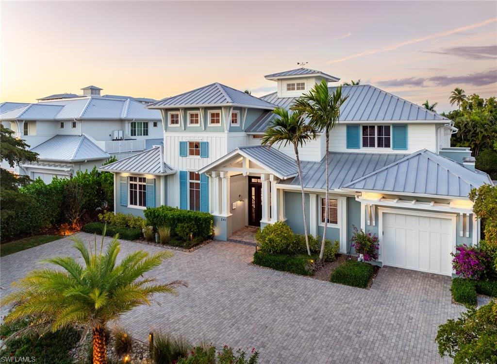 An extraordinary expression of luxury living in Olde Naples steps from the brand new Four Seasons Resort. This exceptional estate offers an enviable lifestyle just a short stroll from the beach and moments from the celebrated dining, shopping and entertainment of downtown. Sophisticated yet effortlessly livable, the residence blends refined interiors with a spectacular private outdoor retreat. Beyond the interiors, a lush tropical oasis unfolds around a stunning resort-style pool and spa accented by dramatic water features. An impressive cabana-style bar and fully equipped outdoor kitchen anchor expansive covered living and dining areas, creating an exceptional setting for intimate evenings or grand-scale entertaining. A private guest cabana completes the resort experience, offering visitors their own secluded retreat. Inside, beautiful wood flooring, gracious proportions and sophisticated finishes establish an atmosphere of understated elegance. The main-level primary suite is a serene sanctuary, while the beautifully appointed chef’s kitchen combines high-end finishes and exceptional functionality for both everyday living and entertaining. Upstairs, additional bedroom suites are complemented by a generous loft providing a private secondary living space ideal for family and guests. Rarely does a residence so seamlessly combine the privacy and indulgence of a luxury resort with the quintessential Olde Naples lifestyle. With the Gulf beaches within walking distance and the boutiques, galleries and acclaimed restaurants of Fifth Avenue South and Third Street South just moments away, this exceptional estate offers an extraordinary opportunity to experience Naples living at its finest.