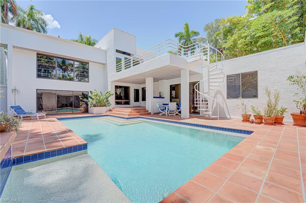 MCGREGOR BLVD HOMES - Welcome to this expertly crafted 4-bedroom, 2.5-bath residence, thoughtfully designed to combine architectural distinction with everyday comfort. A dramatic formal living room with soaring 20-foot ceilings is complemented by a fabulous loft/den that overlooks the space, creating an open and inviting atmosphere. A family room that also overlooks the pool area creates a perfect play space for large family gatherings while the master suite is tucked away from the other bedrooms and is truly your own private retreat. Designed by renowned architect Bruce Gora as his personal family home, this remarkable property is being offered to the public for the first time. The modern architectural design is rich in charm and character, highlighted by a stunning courtyard-style pool setting and two outdoor balconies with peaceful river views. Designer details include wood flooring, a striking metal spiral staircase leading to an upper outdoor patio, and floor-to-ceiling windows that fills the home with natural light. The fully enclosed pool and patio area provides exceptional privacy and features multiple seating areas along with a dedicated space for outdoor grilling—ideal for both relaxation and entertaining, and there is generous storage throughout the property. The home has been carefully maintained, preserving its original character while offering important updates, including an upgraded electrical panel, three air-conditioning units all less than three years old, solar power to help reduce energy costs, and a new roof installed in 2025. Ideally located on Caloosa Drive just off the tree lined streets of McGregor Boulevard, this home sits in one of Fort Myers’ most desirable neighborhoods, only minutes from the dining, shopping, and cultural attractions of Downtown Fort Myers.