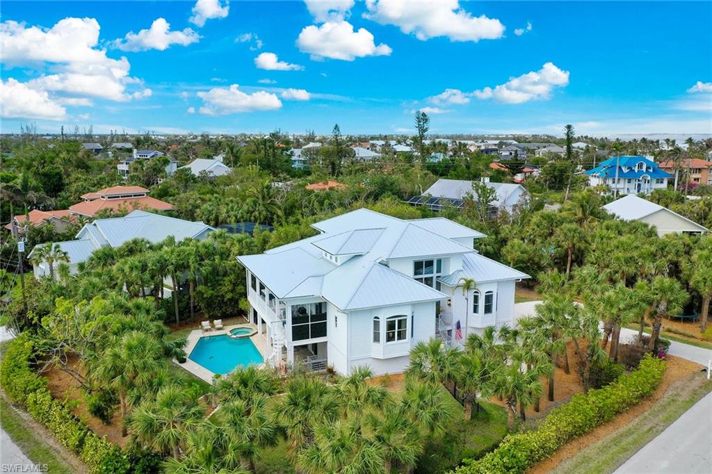 Welcome to 660 Anchor Drive, a distinctive waterfront retreat on the desirable East End of Sanibel. This spacious six-bedroom, four-bath Key West-inspired residence offers an exceptional island lifestyle with canal-front living, a private dock, heated pool and spa, and beach access just a short distance away. Designed for relaxed coastal living and entertaining, the home features generous living spaces, a beautifully appointed kitchen with granite countertops, comfortable bedrooms and a spacious lanai overlooking the pool. A private elevator and oversized three-car garage add convenience, while the private dock with power and water provides an ideal setting for boating, fishing and enjoying Sanibel waterways. Ideally near the beach, bay, restaurants and island amenities. 660 Anchor Drive offers the best of Sanibel, including privacy, space, water access and effortless access to the island's natural beauty. Whether envisioned as a full-time residence, seasonal escape or investment opportunity, this exceptional property embodies the quintessential Sanibel lifestyle.