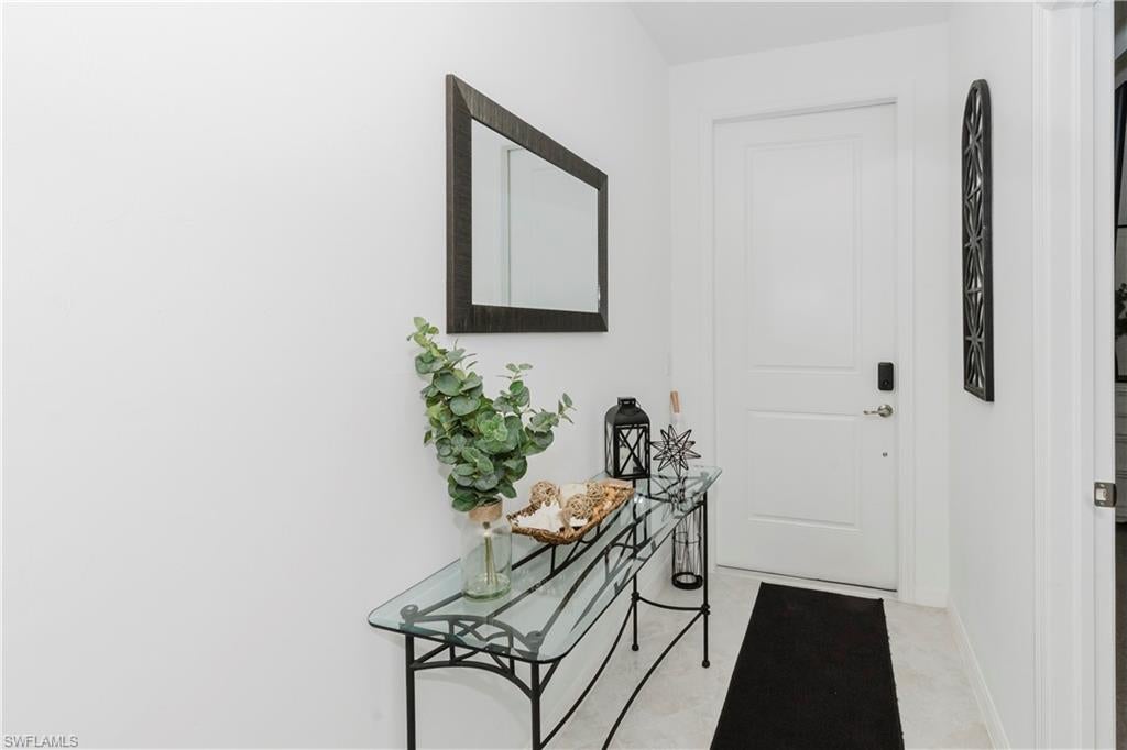 This bright and spacious condo features an open-concept layout, ideal for both relaxing and entertaining. Enjoy a private screened-in lanai overlooking the golf course, lake and lush greenery; your own peaceful escape. The unit includes two well-sized bedrooms, two full bathrooms, and a modern kitchen with stainless steel appliances, quartz countertops, and ample cabinetry. The primary suite offers a walk-in closet and en-suite bath for added privacy. Located in a resort-style, golf course community, residents enjoy access to a wide range of amenities including a championship golf course, clubhouse, fitness center, walking trails, and more. Just minutes from Ave Maria Town Center, restaurants, shops, and parks. Whether you're looking for a full-time residence, seasonal escape, this condo has it all. Also includes covered parking, easy elevator access and in unit washer and dryer. Book today!