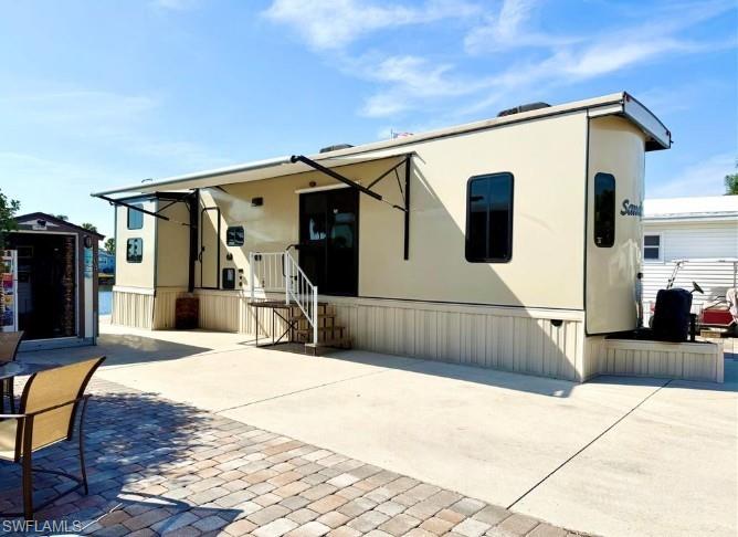 Welcome to 564 Cattleya Refuge in the Imperial Wilderness Condominium Association of Naples, Florida! This 2019 (2Br/1.5Ba) unit, located on the water and situated on LAND that YOU OWN, is being sold furnished. It is brilliantly maintained, features stainless steel appliances, and an atmospheric electric fireplace. The main bedroom contains a queen-size bed, washer & dryer, and generous closet space. The second bedroom offers another queen-size bed, full-size sofa bed, and a drop-down twin bed. The half bath is located off of the second bedroom and the full bath is located near the main bedroom. Outside, you will truly appreciate the relaxing vibe created by patio pavers, a rear grassy yard, lovely water view, and canopy from the RV. Storage space is certainly not a worry since the sale also includes a roomy storage shed. Imperial Wilderness Condominium Association is a location where you own the land when you purchase your home. It is not leased land or a Co-Op. Making this opportunity even more attractive, IWCA was never flooded! Plus, the location is brilliant. It is approximately 3 miles to shopping and restaurants, 11 miles to the Naples beaches, and 8 miles to the Marco Island beaches. Airport access is easily attainable— a 45-minute drive (RSW). Maximizing the opportunity to affordably own in Naples, FL, the HOA fee of $898. per quarter is exceptionally reasonable. That fee covers many of your needs: the advantage of a gated community, water, sewer, lawn care, basic cable, trash, recycling, and community amenities. Community amenities include 2 pools with spas, bocce, pickleball, pétanque, tennis, shuffleboard, billiards, ping pong, a library, clubhouse, 2 dog parks (1 pet, 40lb. max.), nature trail, and an extremely active events calendar— there are over 100 activities available per week! If you are looking for fun or a chance to relax in paradise, this is for you!