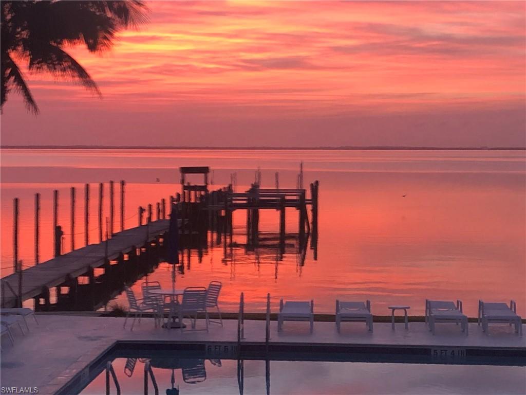 Spectacular, direct Bayfront vistas from this furnished, 2 bedroom and 2 bath condo situated in Captiva's "Village" at Captiva Hide-A-Way. “Boater’s Paradise” - dock your boat right out your back door for easy access to Pine Island Sound and the Gulf. Experience magical sun and moon rises from your private lanai and stunning sunsets from the Gulf beach. Conveniently located close to the marina for all your boating needs. Enjoy some of the BEST fishing on the West coast of Florida! Amenities include a private dock with a RARE opportunity to add your own boat lift, fishing pier, sparkling pool, and BBQ grill. All this just a short 5 minute stroll from the Gulf where you’ll enjoy incredible sugar sand beaches and some of the world's best shelling. Walk into the heart of Captiva's "Village" for dining, shopping, entertainment, marina and more. The building has been totally renovated post hurricane with new roof, siding, windows and lanais. Condo offers tile plank floors throughout main living area and carpet in bedrooms, new air conditioner handler/compressor and tankless water heater. New custom tile and exotic stone and marble vanity in both bathrooms. Stainless steel appliances, granite counters in kitchen and built-in buffet. Owners can have two pets, under 30 lbs.