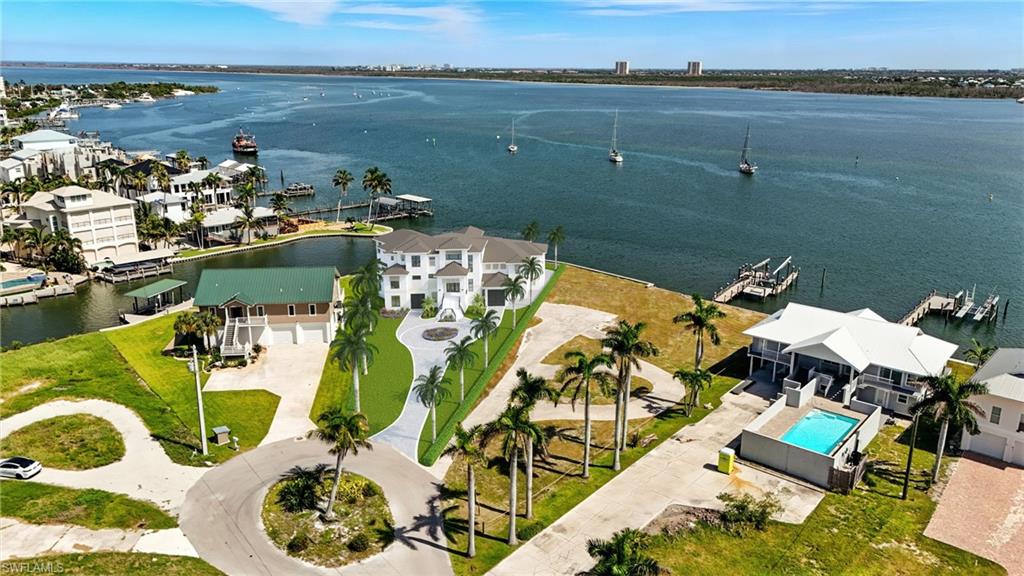 Estero Bay is every boaters dream location with endless water views on the exclusive North End of Fort Myers Beach. Here’s your opportunity to own one of the few remaining large parcels that can support a truly grand, private estate in this beautiful boater's community. Tucked away on a quiet cul de sac, this rare property offers the perfect blend of seclusion and proximity, with the connecting lot also available for sale (MLS#2025007080) —it's an ideal location for the ultimate waterfront compound. The adjoining 16,000 square foot parcel allows you to expand your footprint to nearly an acre of waterfront bliss, all with direct Gulf access, panoramic water views, and room to accommodate large yachts. This site offers everything the most discerning buyers seek—privacy, spectacular water views, and an unrivaled location just minutes from Times Square, Margaritaville, and the island’s top hotspots. The shoreline features 200 feet of protected seawall and intersecting canal frontage with the bonus exceptional deepwater access. Combining both lots would transform the property into an expansive waterfront retreat—perfect for hosting, relaxing, or simply enjoying the horizon from sunrise to sunset.The property is development ready with $350,000 design plans included by acclaimed architect Rich Guzman and styled by Adelyn Interiors. The plans showcase a sleek 6,075 sq. ft. estate with around 17,000 sq. ft. of outdoor living, including an elevated infinity pool, wrap around decks, and multiple outdoor lounges—blurring the line between indoors and out. Utilities are in place for a smooth start and every interior detail has been carefully curated for a flawless finish with the option to customize to your taste. This large site offers endless possibilities—add guest quarters, luxury amenities, or create a sprawling compound. With the ability to combine both parcels, you’re looking at a rare opportunity to build one of the most impressive estates on the island, fully tailored to your vision. Whether you choose to build on one of the lots or both, your vision starts here.