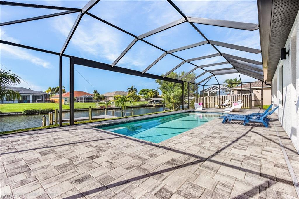 This is a VACATION RENTAL only. Owner will not consider an annual rental. Weekly rentals are permitted.

Spacious 4-bedroom (3 bedrooms plus a flex office with Murphy bed), 2-bathroom Gulf Access pool home located at 136 Kamal Parkway in Southeast Cape Coral. This vacation rental sleeps up to 7 guests and offers direct Gulf Access with a private dock available for guest use.

The open-concept floor plan features a large living area with a sectional sofa and built-in recliners, flowing into a fully equipped, modern kitchen with stainless steel appliances and a dedicated dining room seating 6. A flexible office with a desk and twin Murphy bed offers additional workspace or sleeping accommodations.

The primary suite includes a king bed with direct pool access via sliding doors, and an en-suite bathroom with dual sinks and a walk-in glass shower. Three additional guest bedrooms, each with a queen bed, share a second full bathroom that also serves as the pool bath.

Outdoor living centers on a screened lanai with an electric heated pool, sun loungers, and an outdoor dining area seating 6 — all overlooking the Gulf Access canal and private dock.

Additional features include in-unit washer/dryer, high-speed internet, cable TV, central air conditioning, and ceiling fans throughout. This home is pet friendly, welcoming up to 2 pets with a combined weight of 35 lbs or less (exceptions may be considered upon inquiry).

Ideal for families, boaters, and groups seeking a spacious, well-equipped waterfront retreat in a convenient Southeast Cape Coral location close to Four Freedoms Park, shopping and dining along Del Prado Blvd. and Cape Coral Parkway, and the Cape Coral Yacht Club Beach. Easy access to Fort Myers and Fort Myers Beach via the Cape Coral Bridge.

Maximum occupancy: 7 guests. Smoking not permitted. No events or parties. A utility fee based on average electrical usage is included in the total rental cost.