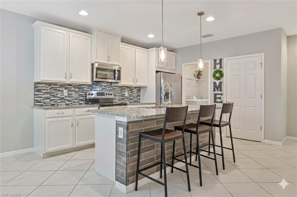 This spacious and thoughtfully designed attached villa offers over 1,500 square feet of comfortable Florida living, featuring 2 bedrooms, 2 full baths, a versatile den, a convenient inside laundry room, and a 2 car garage. The open floor plan creates a bright and welcoming atmosphere, perfect for both everyday living and entertaining. The kitchen is a standout with granite countertops, a stylish backsplash, stainless-steel appliances, and abundant cabinetry for all your storage needs. Throughout the main living areas you’ll find tile flooring, while the bedrooms feature attractive luxury vinyl flooring—providing durability, style, and easy maintenance with no carpet to worry about. No Flood Insurance Required! Located in the gated community of Lindsford, this home offers an unbeatable central Fort Myers location near the historic Downtown River District and convenient access to everything Southwest Florida has to offer. You’re just minutes from I-75, RSW International Airport, and approximately 20 minutes to multiple world-class beaches, shopping, dining, and entertainment. Lindsford residents enjoy an impressive array of upscale amenities, including a beach-entry resort-style saltwater pool and spa, fitness center, clubhouse, community room, bocce courts, fishing pier, and scenic walking and biking trails. Even better, the HOA fees are among the lowest in Fort Myers and include lawn maintenance—making for truly low-maintenance living. Don’t miss the opportunity to own this move-in ready villa in one of Fort Myers’ most convenient and amenity-rich communities.