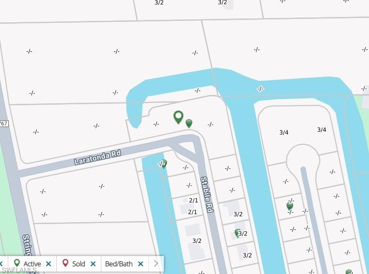 Rare opportunity of its kind: This 1.1 acre freshwater corner lot, with over 500+ ft of waterfront and 350+ ft of road frontage is situated at the entrance to St. Jude Harbors subdivision at the northern end of St. James City, and across from (same seller owned) Gulf-access property (3921 Stabile Road). Though the size and layout of this property may likely offer the opportunity to sub-divide, a brilliant development idea encompasses both properties. The Gulf-access property, which is quite unique in its own way, may provide the site for a guest / boat house (end of direct access canal, offering possibility of expansive dock, etc.) while this site would be a perfect location for a superb, oversized mansion with an additional guest house(s), and still plenty of space to spare. 
The property is partly wooded and has Pine and Melaleuca trees along the waterfront, which will need to be cleared prior to development.
Important: On this property there are several Gopher Tortoise burrows, not clear how many are occupied. These are protected species, however the possibility to relocate these precious burrow-dwellers exists and has to be done by a state certified and approved environmentalist. Being aware that this will necessitate extra permits and effort, the owner also provides an allowance of $30,000.00 for such services. The time to do this may be used to plan your future residence on lovely Pine Island. This is a rare opporunity in many ways. Don't wait!   Now, survey available too!