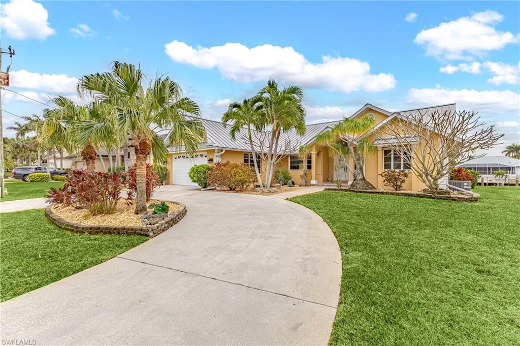ANOTHER HUGH REDUCTION! OWNER SAYS BRING OFFERS!!! Welcome to your dream oasis! It's all about location with this exceptional 3-bedroom, 2-bathroom, 2-car garage home. A masterpiece of modern living with direct, sailboat gulf access just 3 short quick turns to the river and nestled in a prestigious neighborhood just a stone's throw from Cape Harbor Marina, shopping, and dining. The split floor plan is designed for both privacy and togetherness, offering a harmonious flow throughout. Step inside to discover a world of new upgrades: sleek new flooring, fresh interior paint, and charming barn-style closet doors that add a rustic touch. The home is illuminated by stylish new light fixtures and ceiling fans, all cooled by a brand new A/C unit installed in 2023. The kitchen is a chef's delight, featuring ample shaker-style cabinets, luxurious granite countertops, and gleaming new stainless steel appliances from 2023. The adjacent oversized laundry room offer a double wide closet perfect for added pantry space. The master bedroom is voluminous with sliders leading to the lanai. The master bathroom is a sanctuary with a stunning walk-in shower and dual sinks for added convenience. Both the master and guest bathrooms have been beautifully remodeled, offering a spa-like retreat. Outside, a below-ground concrete pool invites you to unwind, while the screened lanai offers the perfect spot for alfresco dining or simply soaking up the sun. New impact windows along with electric lanai shutters provide peace of mind, ensuring your home is a fortress against the elements. This meticulously maintained home is a blend of style, comfort, and functionality, ready to welcome you to a life of luxury and ease. Don't miss the chance to make this property your own. All information deemed reliable but not guaranteed, buyer(s) to do due diligence.