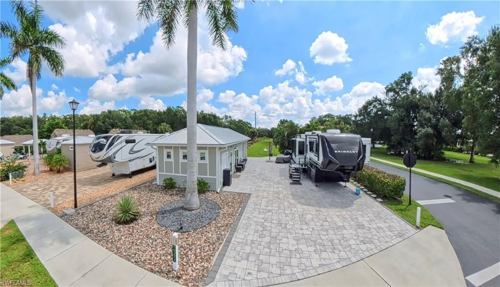 Welcome to Lot 118—currently the only casita available for sale in Cypress Trail RV Resort! Situated on a desirable corner lot, this property features a custom-built, 499-square-foot casita, along with a spacious 15' x 16' open patio designed for Florida-style entertaining.

The beautifully finished casita offers hurricane-impact windows and doors, tile flooring, a mini-split A/C system, custom cabinetry, and a full bathroom with a walk-in tiled shower and modern finishes. The outdoor living area includes roll-down hurricane screens, a ceiling fan, mounted TV, and a well-equipped outdoor kitchen with a farmhouse-style sink, stainless-steel cabinetry, and generous counter space.

A separate golf cart room provides valuable bonus space with endless possibilities. Use it for golf cart parking or additional storage, or customize it by adding a washer and dryer, refrigerator, office, or hobby area. The expansive paver pad provides ample space for your RV and outdoor living. Lot 118 is a rare opportunity to own a distinctive casita property and enjoy the resort lifestyle at Cypress Trail.