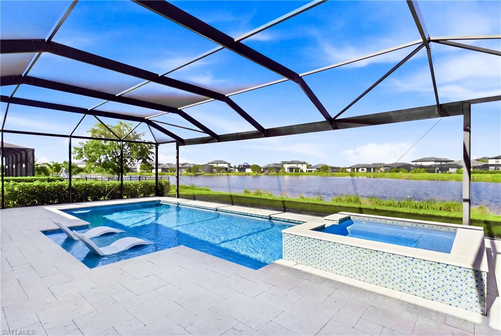 Welcome to this beautifully appointed Summerville floor plan in Timber Creek, where beautiful lake views, a custom saltwater pool, and a spacious, thoughtfully designed layout come together to create the ideal Florida lifestyle. Situated on a desirable lake-view lot, this single-story home offers three bedrooms, a den, three full bathrooms, and a three-car garage. The heart of the home is the oversized kitchen island, offering abundant space for meal preparation, casual dining, and entertaining. The kitchen flows effortlessly into the great room and expansive dining area, creating an inviting space to gather with family and friends. Tray ceilings add architectural detail to the main living area and primary bedroom, while a guest bedroom with its own en-suite bathroom provides added privacy and comfort. The separate den offers versatility for a home office or additional flex space, and the laundry room includes a convenient utility sink. Outside, enjoy your own private retreat featuring a custom saltwater pool with a sun shelf, perfect for lounging and soaking up the Florida sunshine. The panoramic clear-view screen enclosure allows you to take in the picturesque lake views, while travertine tile adds a touch of elegance to the pool deck. Remote-control pool automation makes operating connected pool features convenient and effortless. Inside, glass shower doors add a clean, modern finishing touch to the bathrooms. An attractive exterior and spacious three-car garage complete this desirable home. Timber Creek delivers an exceptional resort-style lifestyle with an award-winning amenity center featuring a full-service restaurant, bar and grill, and resort-style pools. A dedicated lifestyle director coordinates a year-round calendar of events and activities, offering plenty of opportunities to connect with neighbors and enjoy the community. Additional amenities include two fitness centers, saunas and locker rooms, a full-size indoor basketball and volleyball court, tennis and pickleball courts, an arcade, social hall, playground, splash pad, putting green, event lawn, bocce courts, sand volleyball court, and fire pit. Conveniently located near I-75, Southwest Florida International Airport, JetBlue Park, and Downtown Fort Myers, the community also provides easy access to shopping, dining, and everyday essentials along the Daniels Parkway and Colonial Boulevard corridors. With its generous living spaces, oversized kitchen island, inviting outdoor pool area with sun shelf, and beautiful lake views, this Summerville home offers the perfect blend of comfort, entertaining, and resort-inspired living.