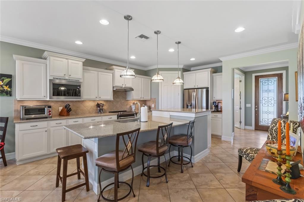GOLF COURSE AND WATER VIEW - FORMER MODEL HOME - 
This CASTLE ROCK floor plan is located on a quiet cul-de-sac in the 55+ Del Webb Naples community, offering a beautiful view of the 18th green of Panther Run Golf Course and lake. Sellers are also including the PLATINUM HOME WARRANTY Package for added peace of mind. A FORMER PULTE MODEL home, it includes crown molding, TILE FLOORING on the diagonal throughout, tray ceilings, and ZERO CORNER sliding doors that open to the lanai. 
Featuring FRESHLY PAINTED exterior and interior with designer accent walls and modern touches and a built-in sound system, IMPACT RESISTANT windows, and a security system.
The gourmet KITCHEN features pull-out drawers, newer appliances (microwave, refrigerator), and upgraded cabinetry. The versatile den is ideal for a home office, creative studio, or additional guest space.
The PRIMARY SUITE offers dual sinks, a relaxing soaking tub, shower, and an EXTRA LARGE CLOSET for ultimate comfort. 
The EXTENDED LANAI with picture-frame screen provides the perfect place to relax or entertain while enjoying the golf and water views.
Additional features include an insulated garage door, newer washer/dryer and an upgraded STONE FRONT ELEVATION.
This home comes with the SOCIAL MEMBERSHIP, but take note GOLF LOVERS,  Panther Run Golf Club offers optional MEMBERSHIPS with premium golf experiences just steps from your backyard.
In Del Webb Naples, you’ll enjoy WORLD-CLASS AMENITIES that rival luxury resorts: dine at the Rusty Putter Restaurant, soak in the RESORT-STYLE or LAP POOLS, break a sweat in the state-of-the-art FITNESS CENTER, and play your way through PICKLEBALL, TENNIS, bocce, billiards - even a top-tier GOLF SIMULATOR!
Need groceries, church, or a bite to eat? Just hop in your golf cart and cruise into town - Publix and the heart of Ave Maria are just minutes away.
This isn’t just a home - it’s a LIFESTYLE UPGRADE in one of Southwest Florida’s most vibrant 55+ communities. Don’t miss your chance to live where fun, fitness, and friendships flourish year-round!