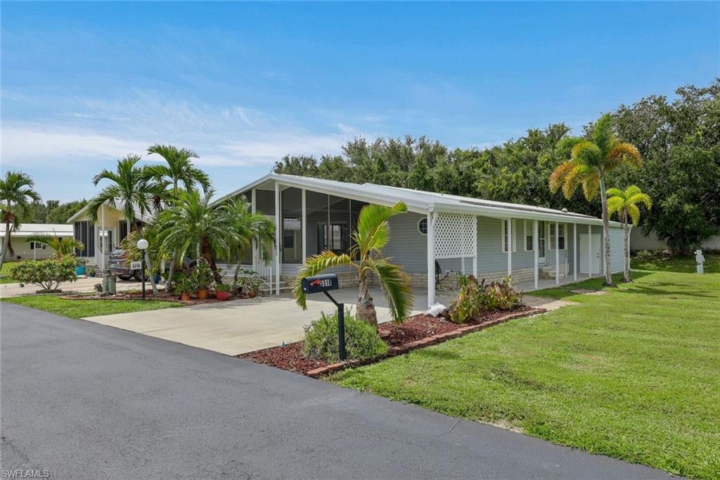 Discover the ultimate Florida lifestyle in the highly sought after 55+ community of Crystal Lakes. This move in ready, partially furnished home offers a rare and valuable opportunity to own the land with no monthly lot rent. Featuring 2 bedrooms plus a den, 2 full bathrooms, over 1,500 square feet of living space, and an attached carport, this home offers plenty of room to relax and entertain. The light filled interior features a spacious kitchen with ample cabinet and counter space, an eat in dining area, and a convenient breakfast bar. The owner’s suite offers two walk in closets and an ensuite bathroom with dual sinks and a walk in shower. Relax and unwind in the large screened lanai/sunroom, complete with added plexiglass tinted sliding windows for year round enjoyment. The outdoor space also includes an additional workshop area, decorative landscaping, and an open lot next door that provides extra space for your pets to enjoy in this pet friendly community. Residents have access to a vibrant and active lifestyle with low HOA fees and an impressive selection of amenities, including a heated pool and spa, clubhouse, tennis, pickleball, shuffleboard, and so much more. Conveniently located in Fort Myers, you are just minutes from Southwest Florida International Airport, JetBlue Park, Six Mile Cypress Slough Preserve, I 75, shopping, dining, and everything Southwest Florida has to offer. Whether you are looking for a seasonal retreat or a place to enjoy retirement, this home offers the perfect combination of comfort, convenience, and an active Florida lifestyle. Schedule your private showing today!