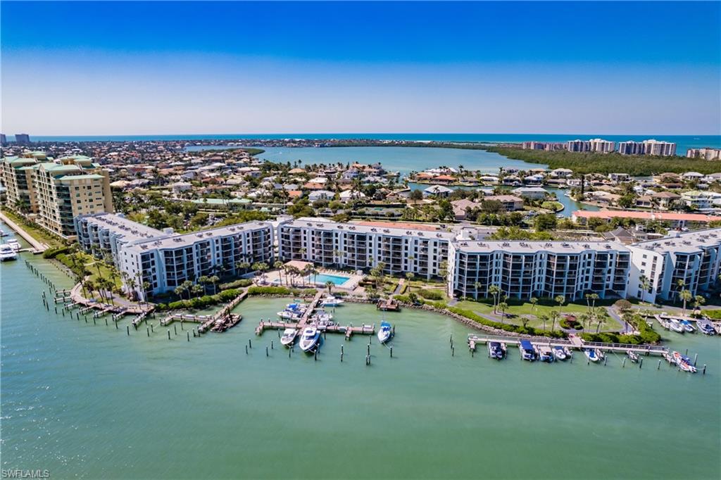 Come and experience island living at its best at Riverside Club, a gated community, and the jewel of Marco Island! The wide water views will never cease to amaze you; offering a serenely beautiful view every single day and night. Whether it is your morning coffee or favorite cocktail, you will be amazed by the dolphins displaying their whimsical talent, the variety of feathered friends fishing and a plethora of other wildlife to observe. The boat traffice passing by Riverside Club is pure entertainment to experience. You will have the opportunity to experince the Key West Express and the Marco Island Princess on a new level as they pass by, ever so closely, to the docks. This condo offers a new washer and dryer, new water heater installed in 2026, a newer AC unit with wifi thermostat, newer appliances and granite counter top, and walk-in shower. Riverside Club has had Category 5 impact resistant sliders and windows installed in all units as well as new lanai cages. Riverside Club's maintenance fees include electric, yes, you heard that correctly...electric is included! With direct access to the Gulf, you can arrive in about 10 minutes. Lease a boat slip for $400 per year; and a locked boat storage yard is onsite. Fish directly from the docks; get competitive at the Pickleball and Tennis courts. Riverside Club offers 2 lap pools and 2 spas. Pelican Pier is on the property here; plan to meet your friends for a Happy Hour! Riverside Club is within walking distance to boat and bike rentals and to the World-Famous Snook Inn--Waterfront Dining and many other restaurants and shops. Rose Marina is less than a mile away, this marina is the launch site for the Key West Express and they offer boat rentals as well.