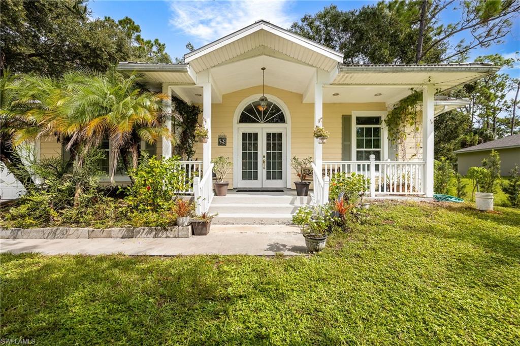 This custom-built home is a one-of-a-kind, and definitely not a cookie cutter.  It is tucked away on a quiet cul-de-sac and backs up to a spacious greenbelt; the two adjacent lots are also available! This Key West-inspired home features and old fashioned Southern Front Porch, and a spacious screened lanai in back.  Inside is a spacious great room with tray ceiling, real hardwood floors, and a bright island kitchen with a walk-in pantry. The spacious primary suite features a HUGE MASTER CLOSET and plenty of storage space! This home features impact windows, a metal roof, concrete Hardie board siding, a tankless water heater, and (city water with a RainSoft water softener). NOT IN A FLOOD ZONE, AND NO HOA! Your dream home is closer than you think, it's right here in beautiful LaBelle at 8004 Vega Court!