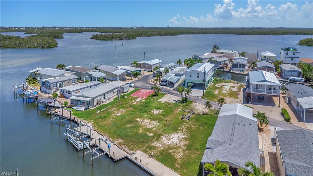 Own your piece of the Fort Myers Beach lifestyle! You OWN the land with Gulf access, and a new seawall already in place. Enjoy boating and waterfront living with convenient access to the water. Located just a few blocks from popular local favorites including Doc Ford’s, Dixie Fish House, and Bonita Fish House. Walk or bike to Margaritaville and Times Square for shopping, dining, entertainment, and the vibrant beach-town atmosphere. This is an exceptional opportunity to enjoy the best of Fort Myers Beach—waterfront access, walkability, and an unbeatable location all in one.