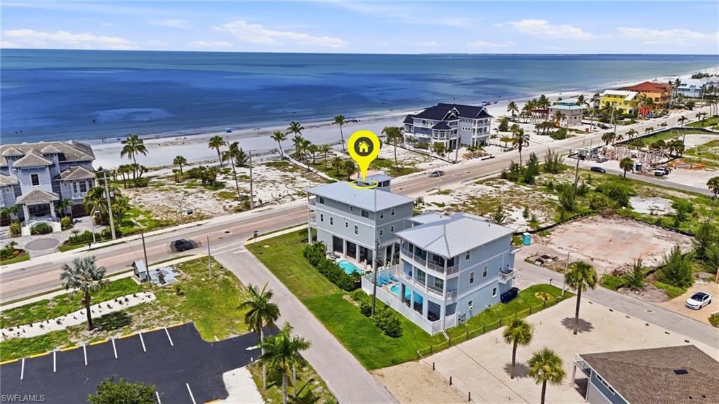 2021-built Luxury POOL home featuring 6-bedroom + 6-bathrooms, Elevator, Sunset Decks and Gulf Views. Deeded beach access across the Street. Perfect for Personal use, blended use or as a high gross income STR with a potential of $250,000+. Designed to accommodate up to 14 guests, this turnkey coastal retreat has the layout, location, and amenities today's luxury owners are actively seeking. Spanning three stories with a private elevator, the home features an impressive observation level showcasing panoramic Gulf-to-Island views, creating an unforgettable guest experience that drives premium rental demand. The open-concept great room is designed for entertaining, featuring plank tile flooring throughout, coastal-inspired finishes, soaring ceilings, crown molding, and walls of impact-rated sliding glass doors that fill the home with natural light and spectacular beach views.

The chef's kitchen offers white shaker cabinetry, stainless steel appliances, and an oversized center island with generous seating—ideal for large family gatherings and vacation groups. Most bedrooms are private en-suites, including dual primary suites, providing exceptional comfort and privacy for multiple families traveling together.

Perfectly positioned overlooking the Gulf of Mexico with deeded beach access directly across the street, guests can enjoy effortless days on the sand, unforgettable sunsets, and the ultimate Southwest Florida vacation experience.



Outside, guests will love relaxing in the heated resort-style pool, enjoying the expansive brick paver patio, and walking directly to the beach in just moments. Two oversized garages provide abundant storage for vehicles, golf carts, beach equipment, and owner supplies.

Built with longevity and peace of mind in mind, this home features a driven piling foundation engineered for 170+ mph winds, impact-resistant windows and doors, and remained high and dry with no flooding in the living areas through multiple hurricanes.

Whether you're looking to maximize vacation rental revenue, complete a 1031 exchange, or own an exceptional second home that generates substantial income while you're away, this property offers an outstanding combination of luxury, location, durability, and investment performance in the heart of Fort Myers Beach.