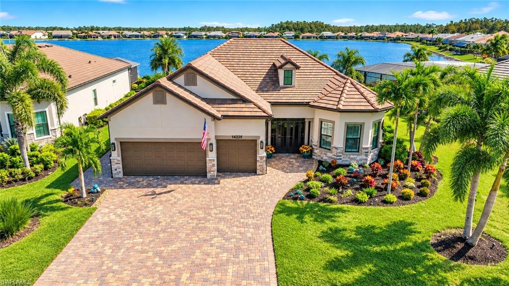 Experience exceptional lakefront living in one of Southwest Florida’s most sought-after resort communities. Privately nestled on a quiet, peaceful, cul-de-sac, this premium homesite offers a rare combination of tranquility, and breathtaking panoramic views of Corkscrew Shores’ spectacular 240-acre lake. An exclusive, highly desirable setting that highlights the breathtaking beauty of the expansive waterfront views, this impeccably upgraded Pinnacle floor plan offers an exceptional blend of luxury, comfort, and indoor-outdoor living. From the moment you arrive, the impressive oversized entry, elegant glass front door with sidelights, and beautifully illuminated landscaping create a striking first impression. Inside, refined architectural details abound, including elegant crown molding, soaring tray ceilings, extensive custom woodwork, plantation shutters, and tile flooring throughout. The gourmet chef’s kitchen features upgraded cabinetry, gorgeous quartz countertops with 12 foot island, under/above-cabinet lighting, gas cooktop, instant hot water, and additional A/C duct in the pantry. The outdoor living experience is equally impressive, with unobstructed, enviable, lake views providing a stunning backdrop for everyday relaxation and entertaining. Enjoy the gorgeous custom saltwater pool/spa, prepare meals in the outdoor kitchen, or unwind in the spacious covered lanai. A newly installed panoramic screen enclosure maximizes the spectacular water views, while hurricane-rated electric roll-down shades, elegant evening lighting, and professionally illuminated landscaping enhance this exceptional outdoor retreat. A paved walkway to the pool adds another thoughtful touch. Designed with comfort, convenience and peace of mind, the home features hurricane-impact glass throughout, a whole-house generator, surge protection, and a whole-house water purification system. The spacious, air-conditioned three-car garage offers epoxy flooring, overhead storage racks, extra-wide attic stairs leading to generous, walkable attic storage. A well-appointed laundry room with utility sink and additional cabinetry, and an extra-wide driveway providing abundant guest parking. Corkscrew Shores offers an exceptional resort-inspired lifestyle with an impressive array of amenities, including a resort-style pool and spa, fitness center, movement studio, massage room, tennis and pickleball courts, basketball, bocce ball, playground, putting green, shuffleboard, walking trails, fishing pier, kayak launch and fire pits. Residents can enjoy community events and activities, as well as the on-site Captain’s Club restaurant and sports bar. The spectacular 240-acre lake permits electric, wind-powered, and manually powered boats, and registered golf carts are permitted. No CDD fees, plus a prime location less than 15 minutes from FGCU, RSW Airport, Hertz Arena, shopping, dining, and SWFL’s beautiful white-sand beaches!