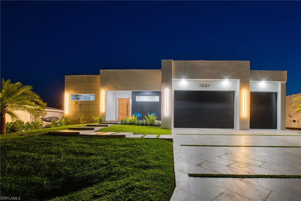 STUNNING CONTEMPORARY RESIDENCE ON BAYSHORE AVENUE! Boaters’ dream in the very desirable Yacht Club neighborhood of Cape Coral. No bridges (sailboat access!) and only a 5 minute boat ride to the Caloosahatchee River/20 minutes to the Gulf. It’s also only minutes away by car or bike from popular shops and restaurants. Gorgeous modern design, including a light and open floor plan, high end cabinetry, appliances, light fixtures, fans, and finishes throughout, tile flooring throughout, a wine cellar, and a gas cooktop and oven. The bright living room leads you to a large gas heated saltwater pool and spa with a Pentair automation system, 3 electric Storm Smart hurricane shades on the pool lanai, a beautiful outdoor kitchen, 3 gas fire pits, and an additional fire pit at the dock with seating around it. There’s also a new 20,000 pound boat lift, tiki hut, and 250 gallon propane tank! The builder thought of everything, and it shows - WELCOME HOME!