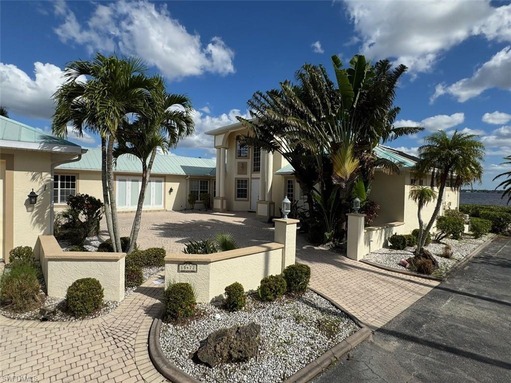 A golden opportunity to avail of a unique property on the River at a price REDUCED by $200,000  A boaters paradise  at a price for the shrewd buyer !!Spectacular Riverside property directly situated on the North bank of the Caloosahatchee River. Yachting boating community on its on harbor w/ direct access to the GULF ! Remodeled in 2013 !!Picture post card views of Water from every room. Property sits on a Private access road. If you desire a superb waterfront residence this is what you are looking for. This home has 320 Feet of River frontage plus 125 feet of deep water canal side with 60 feet of private, home includes TWO deeded slips and one 20,000lbs LIFT. A serious boaters dream! From this water direct boat access to the gulf. Brick paved circular courtyard, a 1300 sf (6) garage with 10.5 foot high ceilings with plenty of room for all ones toys. Guest wing has private entrance with two bedrooms and bathroom. Enter main residence  through double stained glass doors with ascending spiral staircase leading to spacious second floor. with expansive River views from the screened -in- balcony. Tile in main living areas. Kitchen with large island, new cabinets with granite surround, dining room w/coffered ceilings, LG and Samsung appliances, wine cooler, leads to spacious family room with gas fireplace along with full Entertainment center. Master bathroom with stand alone tub, open shower, dual master sinks . Home office /den as well as a powder room. New Pool enclosure and pool has been resurfaced Feb, 2025. Home has been wired security system and Arlo security camera systems also.  Full house plans available. Conveniently  located next to shopping, restaurants, downtown  River district, 10 minutes to 1-75, & 25 minutes to South West International Airport and Punta Gorda Airport. This is an ideal all year round home or winter place in the sun for a shrewd buyer. It must be viewed to experience its magnificence.