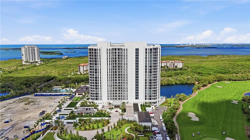 One or more photo(s) has been virtually staged, AI generated or rendered.  Welcome home to a brand-new coastal showpiece at Infinity at The Colony—where elevated design meets effortless, resort-caliber living. Positioned high above the shoreline, this refined residence captures sweeping Gulf and water views through expansive glass, bathing the interiors in natural light and an unmistakable sense of arrival. Enter via your private elevator into a bright, contemporary sanctuary with soaring ceilings and an open layout designed for both intimate evenings and sophisticated entertaining. The chef-inspired kitchen anchors the home, flowing seamlessly into the living and dining spaces—each framed by postcard-worthy vistas. Slide open the doors and step onto your oversized lanai, complete with a built-in grill—the perfect stage for sunrise coffee, sunset dinners, and cocktail-hour moments as the horizon glows. A second private outdoor space adds even more room to unwind, host, and savor the coastal breeze. Life at Infinity is a full-service experience—anchored by a standout collection of amenities designed for both indulgence and everyday ease. Spend your days among multiple resort-style pools, enjoy the convenience of a poolside restaurant, and gather effortlessly in the member’s lounge or game room. Wellness is elevated with a premier fitness center, while recreation takes center stage with pickleball courts and a PopStroke-style golf experience created by Tiger Woods’ architect—a truly unique offering in the luxury space. Even your four-legged family members are pampered with an on-site dog spa and dog park, and when the sun sets, the rooftop terrace invites unforgettable evenings with an outdoor kitchen and firepits—all complemented by 24-hour concierge service and access to The Colony’s private island beach park and the waterfront restaurant, the Bay Club. This isn’t just a residence—it’s luxury coastal living, perfected.
