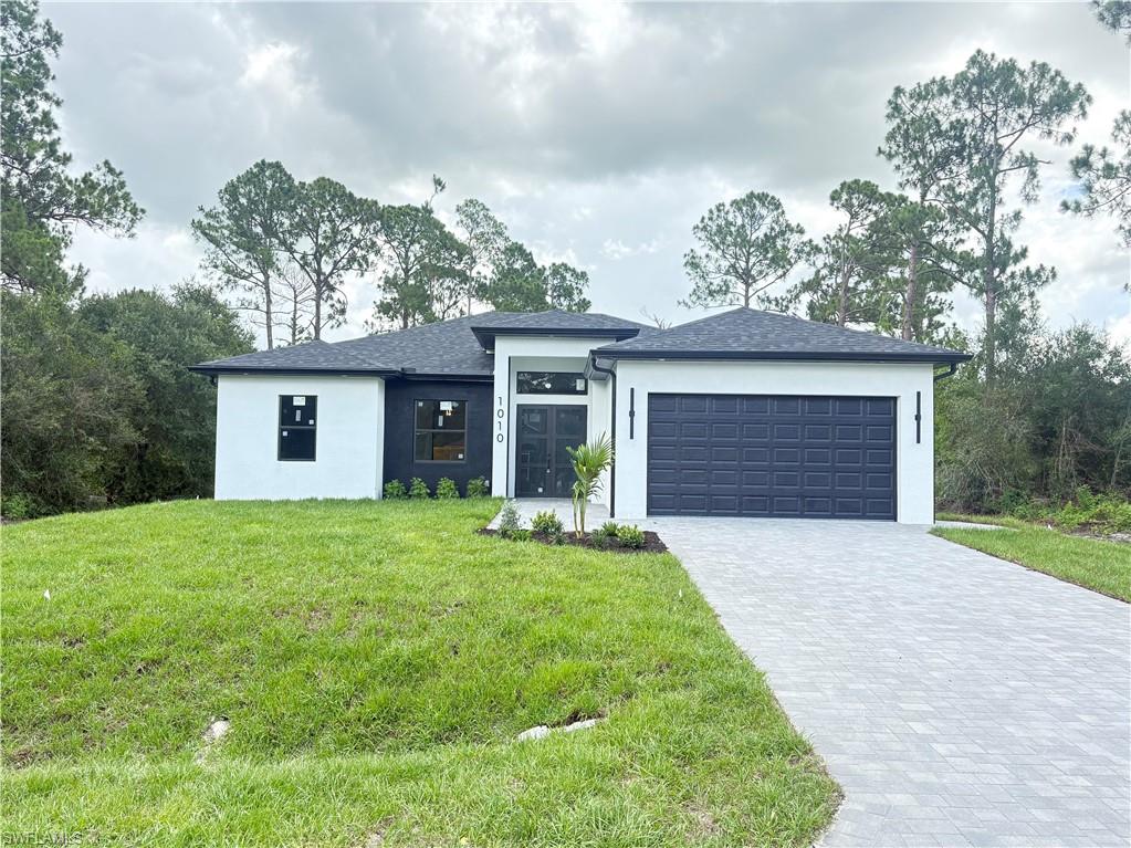 Built in 2026, this beautiful new construction sits on a spacious half-acre lot, featuring elegant impact metal doors and a modern paver driveway that adds style and durability. Modern light fixtures, ceiling fans in every room, and a sleek contemporary fireplace. The gourmet kitchen features a white quartz waterfall island, 42” wood cabinets with crown and light molding, stainless steel appliances, a cooktop, dual microwave/oven, and a stylish hood. A fully equipped outdoor kitchen extends the living space—perfect for Florida entertaining. High-end finishes shine throughout: 24x48 porcelain tile flooring, 10’ ceilings, 8’ interior doors. The luxurious master suite includes a spacious two walk-in closet, a glass-enclosed shower, and a rainfall, waterfall, and massage jet system. Additional features include impact windows and doors, an advanced A/C system with individual room returns, and a full sprinkler system. All information is deemed reliable but not guaranteed. Buyer and buyer’s agent are responsible for verifying all property details, features, and specifications.