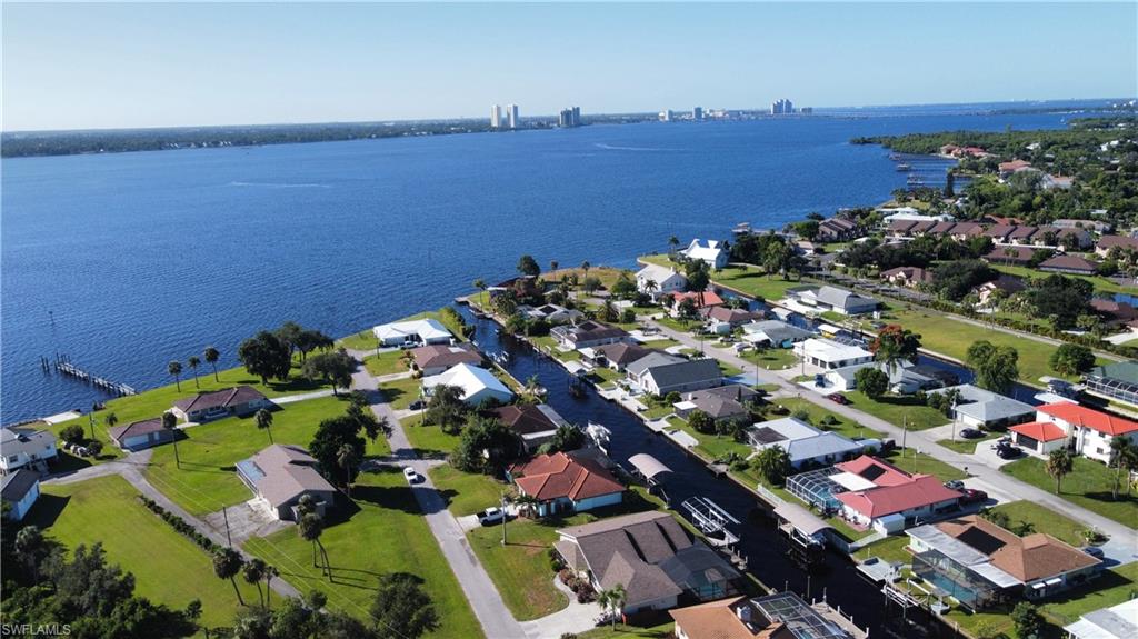 Boaters paradise and just minutes to direct access open water to get you to some of the best fishing and beaches SW Florida has to offer. An amazing value!!! If you love to boat and fish or just be by the water, you shouldn't miss this completely remodeled 3-bedroom 2-bathroom pool home. Open floorplan with vaulted ceilings. The master bedroom and guest bedrooms are at complete opposite sides of the home for privacy. The owners extensively went through the home, so you don't have to replacing the Air conditioning in 2022 Septic system in 2025, saltwater pool equipment with heater 2023, complete kitchen and appliances in 2023, renovated screened pool enclosure and gutters in 2025, electric panel 2023, flooring, bathroom vanities, water heater... etc. All within minutes to shopping, 5 minutes to the interstate and 20 minutes to SW Florida International Airport.
