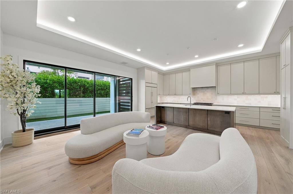 Introducing Residence 205 at Stella Naples, an award-winning boutique collection of just nine signature residences in the heart of Olde Naples. Completed in 2024 and ideally positioned just moments from Fifth Avenue South, this sophisticated coastal residence pairs exceptional design with the ease, privacy, and walkability that make downtown Naples so coveted. The two-bedroom Aria residence offers 2,131 square feet of beautifully curated living space, with two spacious ensuite bedrooms and a rare private rooftop deck suite that elevates the indoor-outdoor lifestyle. An expansive west-facing lanai extends from the main living area and features a private gate leading directly to the sparkling 42-foot pool and lounging areas. Inside, refined finishes and thoughtful details create a sense of understated luxury. Wide-plank European white oak flooring, custom Ruffino cabinetry, Cambria quartz countertops, designer hardware and statement fixtures set the tone, while LED-integrated lighting, indoor and outdoor fireplaces, motorized window coverings, solid-core doors, and a premium appliance package deliver comfort and sophistication throughout. Designed by MHK Architecture, Stella Naples reflects a distinctive modern coastal aesthetic grounded in its Olde Naples setting. The project was named a Grand Winner at the 2025 Aurora Awards, one of the Southeast’s most prestigious honors in residential and commercial design, recognizing its architectural character, indoor-outdoor integration, and thoughtful, place-driven design. With only nine residences, Stella offers an intimate level of exclusivity rarely found in downtown Naples. Each residence includes 10-foot ceilings, two deeded parking spots, ample guest parking, private storage, access-controlled entry and professional building management for effortless lock-and-leave convenience. The building is also pet-friendly, welcoming up to two pets. And the location is exceptional: step outside and stroll to the boutiques, galleries, restaurants, and vibrant energy of Fifth Avenue South, with the sugar-white beaches of the Gulf just beyond. Residence 205 presents a rare opportunity to own a newly completed, architecturally recognized residence in one of downtown Naples’ most distinctive boutique communities.