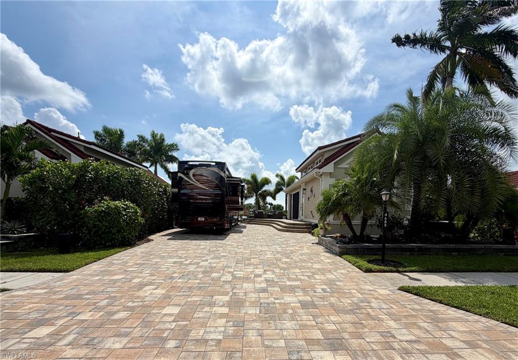Lakefront move-in ready upgraded Class A motorcoach site in Pelican Lake Motorcoach Resort. Featuring a desirable pull-in orientation, wide-open water views, and southern exposure, this property offers an inviting setting to enjoy the Florida sunshine from your motorcoach.

Spanning 4,356 square feet, the site features a paver pad, a raised and extended outdoor patio, and a separate golf cart parking area. Surrounding tropical landscaping creates a lush, private backdrop for relaxing or entertaining beside the lake.  The landscaping is finished with low voltage night lighting.

A custom-built, 308-square-foot coachhouse completed in 2023 that enhances the property, complemented by a 308-square-foot screen room added in 2025.  Together, these spaces provide added versatility and sheltered outdoor enjoyment, making the most of the site’s waterfront setting. 

A few extras to mention: marine style pedestal installed in 2023, coachhouse furnishings included with the sale, and two-piece outdoor bar with grill and griddle included. with the sale.

Take advantage of this move-in ready property now and start enjoying this season!

Coach house & screen room Details:

Built in 2023 this coachhouse has a floor plan that includes a full kitchen with granite countertops, tile backsplash, stainless steel refrigerator, dishwasher, oven, and microwave, full bathroom with walk-in shower, washer & dryer, spacious living area with queen size murphy bed and side storage, loft with queen size bed, tasteful railing, and library ladder for easy access, and the ceiling had a decorative wood finish with up lighting. 

The recently added screen room finishes this property off perfectly. It is finished with power screens on all three sides and a separate doorway for easy access.  This area can be used as an open gazebo to create shade at any time of the day as well.  (outdoor furnishings excluded from sale)