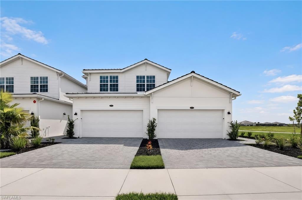 MOVE-IN READY!! This home comes with a bundled social membership to the club — an exceptional value woven right into your purchase. From the moment you arrive, you're not just a resident; you're a member. This spacious 2,110-square-foot two-story home offers a two-car garage on the lower level, providing ample space and convenience. Step inside to an open main floor where the gourmet kitchen shines with granite countertops, a large center island, walk-in pantry, and GE stainless steel appliances, all illuminated by recessed lighting. The kitchen flows seamlessly into the dining and great room, featuring vaulted ceilings, wood-look tile flooring, and crown molding, creating an inviting space for gatherings. Upstairs, the owner’s suite boasts private lanai access, two walk-in closets, and a luxurious bath with quartz countertops, double sinks, a soaking tub, and a large walk-in shower. Two additional bedrooms are located at the front of the home, perfect for family or guests. Energy-efficient features like a Wi-Fi enabled smart thermostat, tankless water heater, and solar-ready roof add modern comfort and savings. With its thoughtful design and premium finishes, this home is sure to attract attention quickly—don’t miss your chance to make it yours! Prices, dimensions and features may vary and are subject to change. Photos are for illustrative purposes only.