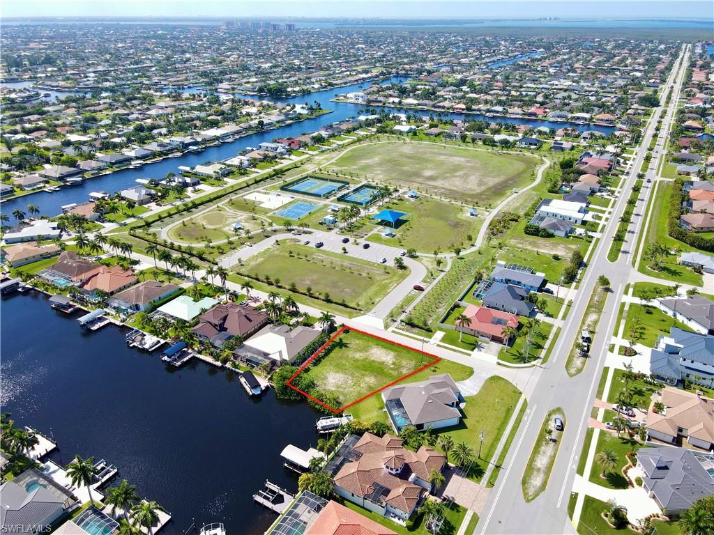Fantastic opportunity to build your dream home on this oversized premier residental Gulf access lot in one of Southwest Cape Coral's most desirable neighborhoods. Ideally located directly across from Sands park which features pickleball, basketball, volleyball, tennis courts, walking paths, playgrounds, and open green space. Surrounded by gorgeous Gulf access homes on a 200 foot-wide canal this lot offers a great location with convenient access to Cape Harbor Marina, restaurants and schools. City water and sewer assessments are in and PAID IN FULL. Whether you're ready to build now or invest for the future, this exceptional lot offers the perfect combination of location, value, and lifestyle.