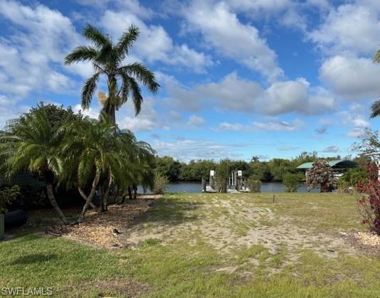 This waterfront lot has Spectacular views and sunsets, also boats and manatees are abundant. The property is in a 55+ waterfront community of Orange Harbor Co-op, situated on the Orange and Caloosahatchee Rivers.  It will make a beautiful spot to build the home of your dreams! Also comes with a boat lift rated at 7,000 lbs. Deck has been treated with clear water protection coating before Ian.  Price includes share for lot and ownership in the co-op with a low monthly maintenance fee of $407, which includes private streets, professional management, water, sewer, trash pick-up, lawn mowing, fiber optic internet and all amities of the community including heated pool, pickle ball, bocce ball, shuffleboard and many clubs and activities clubhouse and two boat ramps.  Two pets total per household are welcome. Some dog breeds are prohibited so be sure to review the community rules. ESA or service animals are allowed. All buyers must be approved by management.