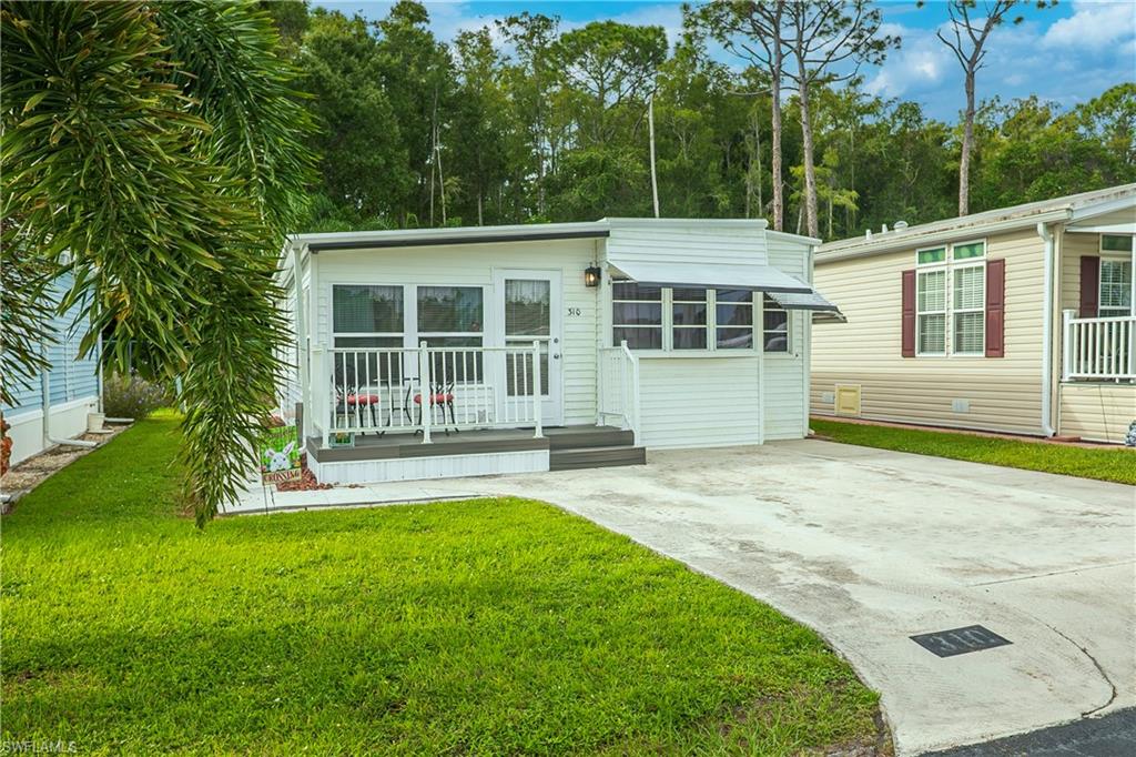 Located in the desirable Fountain View RV Resort, a well-established 55+ community where you own the land, this turnkey-furnished 1-bedroom, 2-bath residence offers approximately 655 square feet of comfortable living space and a desirable perimeter location backing to a wooded area for added privacy. The interior features updated flooring, window blinds, ample storage, and the convenience of an in-residence laundry area with a stackable front-load washer and dryer. A combined walk-in pantry and closet provides additional storage, while the guest bathroom features a convenient step-in shower. Outdoor living is enhanced by a welcoming front porch with low-maintenance composite decking, perimeter pavers, and a covered rear porch with cement pavers overlooking the wooded area and small yard. Clamshell awning shutters provide additional protection and shade, while an aluminum roof-over completed in May 2024 is an important recent improvement. Fountain View residents enjoy an active Florida lifestyle with an impressive selection of recreational amenities, including a clubhouse, community pool, spa/hot tub, bocce, shuffleboard, tennis, volleyball, basketball, and community laundry facilities. Optional RV and boat storage are also available. The monthly HOA fee is approximately $264.50 and includes cable, water, sewer, trash, lawn and land maintenance, community laundry facilities, on-site management, recreational facilities, reserves, streetlights, and street maintenance. Conveniently located near shopping, dining, medical facilities, golf courses, downtown Fort Myers, and Southwest Florida beaches, this deeded property offers an affordable opportunity to enjoy the Florida lifestyle in an established 55+ community.