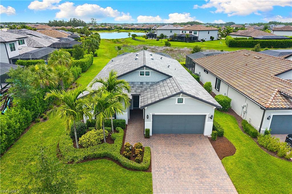 LIGHT AND BRIGHT, COASTAL STYLE SUMMERWOOD MODEL WITH POOL AND LONG MARSH/LAKE VIEWS IS AVAILABLE NOW IN THE PLACE AT CORKSCREW! Built in 2022, this residence offers 2 Bedrooms + Den, 2 Baths, 3 Car Tandem Garage with epoxy floor and 4' EXTENSION, 1861sf living area. Enjoy Florida living with the SPECTACULAR INDOOR/OUTDOOR SPACE this home provides. You’ll walk out to the EXTENDED, WRAP-AROUND COVERED LANAI through the pocketing sliding doors. The Covered Lanai is appointed with a PRIVACY WALL and an OUTDOOR KITCHEN. Enjoy relaxing in your HEATED, SALTWATER POOL with AUTOFILL and embrace the tranquil sounds from the RAISED WALL with SHEER DECENT WATER FEATURE. The outdoor space overlooks littoral grasses leading down to the lake for a private peaceful view. There is even PLENTY OF ROOM TO ADD A FENCE BEYOND THE POOL CAGE for your children or pets to play. The White Kitchen showcases UPSCALE GRAY QUARTZ Countertops, Marble Arabesque Backsplash, UNDER CABINET LIGHTING, BUILT IN STAINLESS STEEL APPLIANCES, WALK IN PANTRY and OVERSIZED KITCHEN ISLAND with END CAPS. The Great Room shows off four small windows and opens up to the lanai as well as the dining space. This home features transitional TILE THROUGHOUT (NO CARPET) making it easy to keep clean and pet friendly. PLANTATION SHUTTERS and CROWN MOLDING elevate the interior spaces along with designer ceiling fans and light fixtures. The Primary Bedroom overlooks your pool and peaceful view. The Primary Bath boasts DUAL SINKS, QUARTZ countertops, FRAMELESS HEAVY GLASS SHOWER ENCLOSURE, Private Water Closet, Linen Closet and LARGE WALK IN CLOSET. The Den with double glass door entry offers a retreat for lounging, working or even another place to sleep. Guests will relax in the front bedroom and utilize the hall bath with QUARTZ Countertops & FRAMELESS HEAVY GLASS ENCLOSURE. The laundry room has been thoughtfully enhanced with ADDED SHELVING AND WHITE CABINETRY. STACKABLE WASHER/DRYER is included. The Garage is equipped with EPOXY FLOOR, STORAGE RACKS, a Whole Home SURGE PROTECTOR and extra space provided by the 4’ EXTENSION and the 3rd Car Tandem set up. For added peace of mind, this residence includes ELECTRIC AND MANUAL STORM SCREENS on the Lanai and ACCORDION SHUTTERS on all windows as well as a WESTINGHOUSE 7600 WATT WHOLE HOME PORTABLE GAS GENERATOR. Front and Back pavers have been professionally sealed. THIS PROPERTY IS HIGH AND DRY AND LOCATED IN FLOOD ZONE X... NO FLOOD INSURANCE REQUIRED! The Amenities include Resort Pool w/100' Waterslide & Spa, Indoor Restaurant and Bourbon Bar, Cafe, Outdoor Bar, Fitness Center, Movement Studio, Tennis, Pickleball, Bocce, Basketball, Playground, Dog Park, Childwatch, Spa Services, 2 Entry Gates. Just Minutes to Schools, Shopping, Restaurants, Airport, Beaches. PUBLIX GROCERY STORE PLAZA, JUST 1.4 MILES AWAY! OTHER TENANTS INCLUDE DUNKIN DONUTS, UPS STORE, LEGNO ITALIAN RESTAURANT, NAIL SALON, AND MORE!