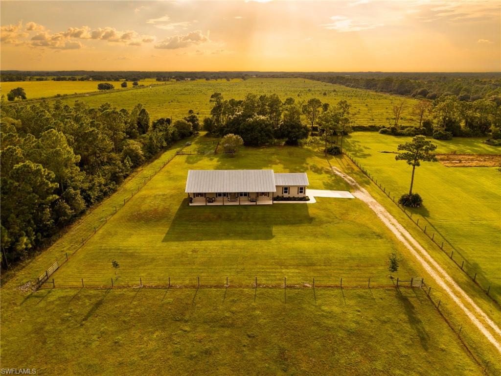 Ten private acres, room to roam, and the kind of peace that's getting harder to find. Tucked away in the Fort Denaud/LaBelle area, this 3-bedroom, 2 bath concrete block home offers just under 2,000 square feet of living space surrounded by the natural beauty and breathing room of country living. The property was chosen and built as a place to raise a family, enjoy the outdoors and create a life away from the confines of a traditional neighborhood and that's exactly what it has become. Outside is where this property truly comes to life. Ten acres provide plenty of room for kids and pets to run, livestock to graze and family and friends to gather. A beautiful cypress head driveway entrance creates a distinctly Old Florida backdrop, while a pond offers a place to fish, pasture provides room for cattle or other livestock, and the expansive yard leaves space to simply enjoy being outside. Deer and wild turkey are frequent visitors, and mornings and evenings are best spent on the front porch watching the sunrise or sunset with nothing but the sounds of the country around you. Despite the privacy, you're not giving up convenience. The sellers describe the property as "secluded yet close to town," offering a rare balance between peaceful rural living and everyday necessities. A shared gated entrance and driveway serve this property and two neighboring homes, creating a tucked away setting where the sellers say their neighbors have become like family. The home itself is concrete block construction and includes a brand-new HVAC system installed in 2026. The washer and dryer are also planned to remain with the home. Whether you're looking for space for livestock, a place for your children to grow up outdoors, or simply somewhere you can come home at the end of the day and truly exhale, this property offers something increasingly difficult to duplicate.