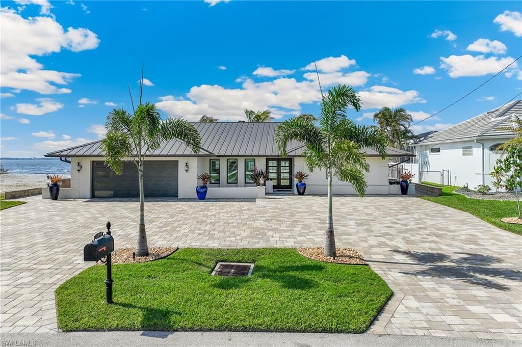 Welcome to your dream home on the river in beautiful Cape Coral! This exquisite three-bedroom, three-bathroom residence offers breathtaking views of the river from every room, creating an idyllic backdrop for daily living. The heart of the home is a gorgeous kitchen, featuring an expansive layout with luxurious granite countertops that's truly a culinary paradise. Every detail of this home has been thoughtfully updated, with everything new pre-hurricane and no flooding. The property boasts a new roof and an electric T-pole installed after Hurricane Ian, ensuring peace of mind. All windows and doors are impact-resistant, providing both safety and energy efficiency. The home is equipped with a state-of-the-art security system for added protection. Comfort is paramount, with new air conditioning and ductwork, alongside updated Pex plumbing and attic insulation for optimal energy performance. The elegant travertine pool deck and sidewalk extend your living space outdoors, perfect for entertaining or simply enjoying the serene environment. The outdoor amenities are equally impressive, featuring a new dock and seawall, along with two boat lifts (24,000 lb and 10,000 lb) and a boat canopy that is just three months old. A remarkable 9 ft concrete captain’s walk stretches from lot line to lot line, offering a stunning vantage point to soak in the waterfront views. Additional highlights include a convenient ice machine, a pool heater, a hot tub for relaxation, and a secure safe for your valuables. Notably, this home has no drywall damage from the hurricane, and the post-hurricane porcelain tile floors from Coretec add both style and durability. Don’t miss this incredible opportunity to own a piece of paradise in Cape Coral! Schedule your private showing today and experience the beauty and luxury of riverfront living!