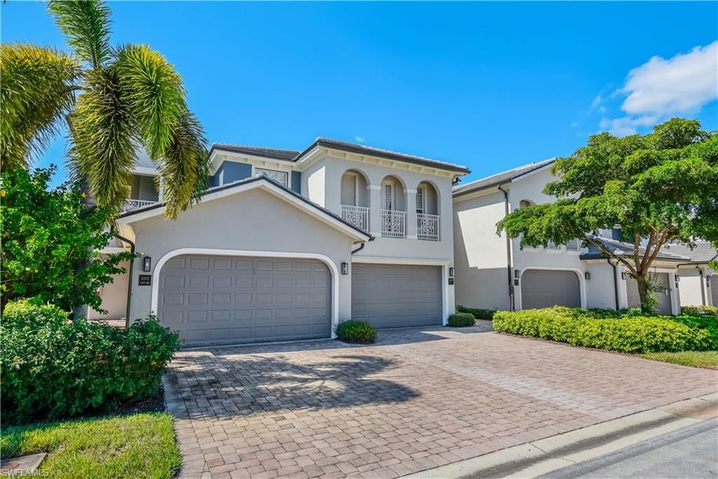 FIRST-FLOOR LIVING | PEACEFUL PRESERVE VIEWS | MEADOWS OF ESTERO Enjoy inviting indoor-outdoor living and tranquil preserve scenery in this first-floor, freshly painted coach home in gated Meadows of Estero. Tray ceilings, crown molding, arched niches, and decorative columns lend character to a spacious interior featuring a separate dining area and an open living room with sliding glass doors to the lanai. Tile flooring flows through the main living areas, complemented by wood-look luxury vinyl in the primary bedroom and den.

The kitchen pairs rich cabinetry with granite countertops, a tile backsplash, stainless steel appliances, and a raised breakfast bar. A window-lined breakfast nook frames beautiful trees and foliage, creating a welcoming spot for morning coffee. A 2025 KitchenAid refrigerator and garbage disposal add practical updates.

The primary suite offers direct lanai access, a tray ceiling, and a generous walk-in closet fitted with extensive shelving and hanging space. The primary bath features dual sinks, a seated vanity, a jetted tub, and a separate shower. A guest bedroom with an en suite bath, a den/office with a closet, and a powder bath provide comfortable accommodations and flexible living space.

The spacious screened lanai offers room for outdoor dining and lounging against a backdrop of mature trees and lush greenery. Tile flooring, electric storm shutters, and an added water connection enhance this outdoor retreat. Additional conveniences include an interior laundry room with cabinetry and a utility sink, an attached two-car garage with an epoxy-coated floor, and a paver driveway. A 2025 new roof and recently painted building exterior complement the home, while Hotwire cable and internet are included in the association fees.

Set among lakes and natural preserves, Meadows of Estero offers a clubhouse, fitness center, community pool, and spa. Its location west of US-41 places shopping and dining at Coconut Point nearby, with nature trails, historic attractions, and paddling opportunities at Koreshan State Park. Convenient access to Florida Gulf Coast University, Southwest Florida International Airport, and the greater Naples and Fort Myers areas completes the appeal. Meadows of Estero is a wonderful, peaceful, convenient community in which to live and entertain family and friends.