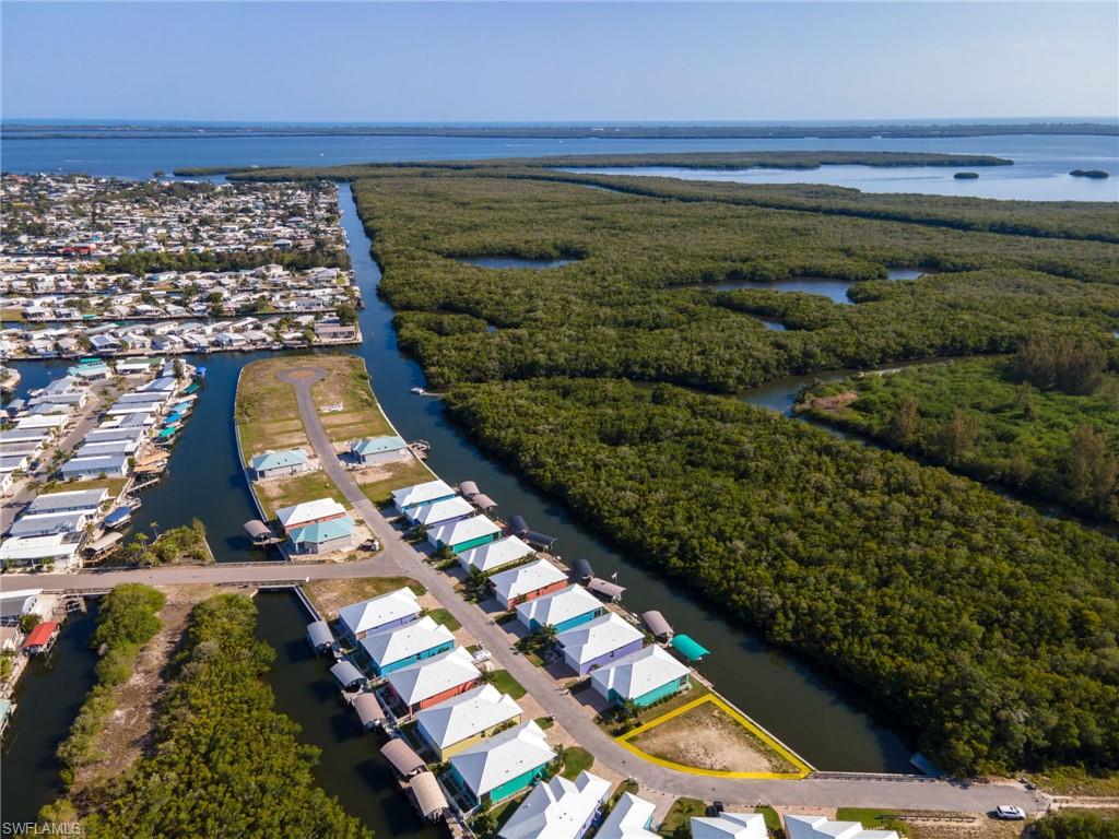 Buy now and build later or get started today. Looking for a home? We'll connect you with the community builder or recommend another great local builder. This oversized lot is situated on the West Side of Treasure Cove and Overlooks Mangroves for a view that will NEVER be replaced by something man-made. Because of its large size, you could build a Bigger House, ADD A POOL, Larger Garage, the possibilities are endless. This development offers sewer which allows you to fit a much larger home than other areas of St James City and NO septic to maintain. With 100 ft of seawall you can place your lift to the side and enjoy the beautiful water views. Cleared and ready to get you on "Island Time".