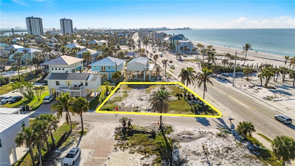 One or more photo(s) has been virtually staged, AI generated or rendered. UNLIMITED SUNSETS– ACROSS THE STREET FROM THE BEACH! PRIVATE NEIGHBORHOOD BEACH GAZEBO + BAYFRONT PARK WITH FISHING PEIR . WEEKLY RENTAL ZONING. Build Your Dream Home! This Oversized 95' X 88' & 100'+/- corner lot, located directly across from the Sandy Beach, offers the perfect opportunity to build your ideal home or vacation rental. With side street access, the property provides added convenience and potential for easy development. Zoned for weekly rentals, the lot promises high-income potential. Whether you envision a luxurious waterfront retreat, or a captivating vacation home, this property offers the ideal foundation to turn your vision into reality. Don't miss your chance to own a slice of paradise in one of Fort Myers' most sought-after locations. Enjoy the best of beach living with just a short walk or bike ride to local shops, Margaritaville, and more! Convenience is key, as this property is just a stone's throw away from amenities such as Publix, the marina, and shops, ensuring that everything you need is within easy reach. Whether you're envisioning a luxurious beachside retreat or a lucrative rental property, this lot offers the perfect canvas to turn your vision into reality. Builder introductions are available, ensuring a smooth path to bring your vision to life.