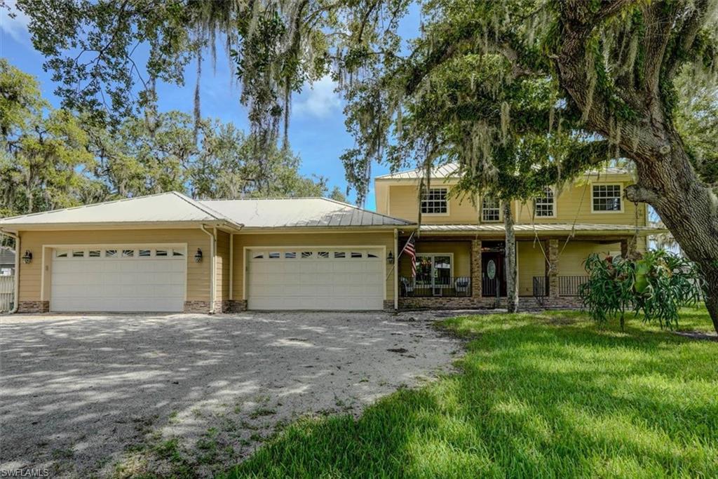 CUSTOM ONE-OF-A-KIND home designed for the discerning buyer who appreciates QUALITY CONSTRUCTION, craftsmanship and exceptional attention to detail. Situated on TWO LOTS totaling over 1/2 acre, this impressive 5-bedroom, 3.5-bath residence offers 3,310 SF UNDER AIR and approximately 6,000 SF UNDER ROOF.

Built for durability, BOTH STORIES feature SOLID CONCRETE BLOCK CONSTRUCTION with an exterior moisture barrier beneath Hardie cement board siding and trim—NO WOOD EXTERIOR SIDING. A seamless metal roof with no exposed screws, working vented cupola, and total exterior repaint in 2022 further enhance the home. Crawl-space construction provides valuable access to plumbing, electrical and cable systems. Four totally independent central A/C systems allow customized temperature control throughout the home. Additional features include tankless LP water heater with electric backup, underground LP tank and electrical service, central vacuum, security wiring and exterior security lighting.

The main-floor primary suite encompasses approximately 656 SF with two walk-in closets, private A/C, slider to the lanai, walk-in shower, Jacuzzi tub and dual sinks. Solid wood flooring, custom tile, wood doors and baseboards, custom wood blinds and an impressive oak staircase showcase the craftsmanship throughout.

The spacious chef's kitchen features granite countertops, hardwood cabinetry, two-level center island, walk-in pantry, dual stainless sinks, LP gas cooktop, electric range, dual microwaves vented outside, tiled backsplash and breakfast nook. The Expansive Great Room opens to the kitchen and features solid hardwood floors, fieldstone LP gas fireplace and two 8' sliders to the lanai. A formal dining room with tray ceiling completes the main living area.

Upstairs offers THREE additional large bedrooms plus a SELF-CONTAINED APARTMENT/IN-LAW SUITE with its own A/C, kitchenette and full bath—ideal for extended family, guests or private quarters.

Outdoor living includes heavy-duty screened lanai with custom tile, built-in 3-burner stainless gas grill and fieldstone columns, plus a spacious PVC privacy-fenced backyard with ROOM FOR A POOL.

CAR ENTHUSIASTS, HOBBYISTS & BUSINESS OWNERS will appreciate the OVERSIZED 4-CAR GARAGE with hurricane-braced doors, rear-yard access door, air-conditioned office/hobby room, utility sink, cabinetry and abundant overhead storage. PLUS an 18' x 8' storage shed and gated side storage.

NO HOA! An extraordinary custom property offering space, privacy, flexibility and construction quality rarely found in one home. MUST SEE TO FULLY APPRECIATE ALL THE CUSTOM FEATURES!

SELLER FINANCING AVAILABLE FOR QUALIFIED BUYERS WITH 50% DOWN — TERMS NEGOTIABLE.