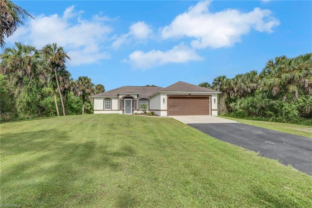 Discover the perfect blend of privacy, tranquility, and versatility on this 1.59-acre property in Golden Gate Estates! Surrounded by nature, this partially renovated, single-story home features vaulted ceilings, crown molding, an updated kitchen with quartz countertops, and a flexible den that can serve as a third bedroom, home office, or guest space. The two-car garage is equipped with a mini-split system for added comfort. Recent improvements include a freshly painted exterior, a new Airtemp HVAC system installed in 2020, and a replaced drain field in 2018.

A standout feature of this property is the impressive 30' x 75' steel building, constructed in 2020! Offering 2,250 square feet under roof, the structure includes a 30' x 50' enclosed area and a 30' x 25' covered carport, ideal for vehicle storage, equipment, recreational toys, or outdoor entertaining. Built with 6-inch concrete floors throughout, the building features two oversized 12' x 12' roll-up doors at the front and rear, plus an additional 10' x 10' roll-up door on the east side for convenient access. 

Situated on a mostly cleared, dry lot, this unique property offers exceptional space and flexibility for hobbyists, collectors, outdoor enthusiasts, or anyone seeking room to spread out. Enjoy the peaceful Golden Gate Estates lifestyle with the added benefit of a substantial detached building and endless possibilities to make this property your own!