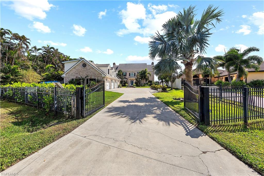 YOU WILL BE AMAZED AT THE ARCHITECTUAL DESIGN AND CRAFTSMANSHIP IN THIS ONE-OF-A-KIND RIVERFRONT ESTATE WITH MILLION DOLLAR VIEWS! Enter the Gated Entry Driveway and Courtyard to an Impressive Estate Home on Over 1/2 Acre on the Beautiful Caloosahatchee River! Walk through the Front Door and look UP... to a Soaring 3 Story Foyer, with Elegant Custom Stairs and Railings, White Porcelain Tile Floors and an Amazing Crystal Chandelier...WELCOMING You in to Explore the Amazing Designs, Architecture, and Master Craftsmanship in the Built-ins, Trims and Finishes in EVERY ROOM and around every Window and Door...Reminiscent of Timeless Classic Designs in Custom Home Building! The Foyer opens to a Formal Dining Area, an Office and the Living/Family Area, which Features a Real Wood Burning Fireplace with Custom Built-Ins and a Wall of French Doors and Arches with more Detailed Woodwork Trim and Finishes...AND MORE MILLION DOLLAR VIEWS! The HUGE Gourmet Kitchen features New Custom Cabinetry and Large Island with Quartz Countertops, Top-of-the-line Stainless Steel Appliances, including a Cooktop with a Real Vented Hood, and More Views! Relax in the Sitting area beside the Kitchen Fireplace and Butler's Pantry, or have your morning coffee at the Bay Window Breakfast Nook or Gather Family and Friends around the Island! The Second Floor Features Real Wood Flooring, 2 Guest Rooms, and a HUGE Primary Suite with MORE MILLION DOLLAR VIEWS and a full length Balcony overlooking the Pool and River with a Spiral Stair to Take to Down to the Pool Deck below. The HUGE Primary Suite has MULTIPLE CLOSETS and Custom Built-Ins, and a Large Primary Bath with a Soaking Tub and Custom Glass Shower. The Guest Bath offers a Jetted Tub Shower Combo. ENJOY Mile Wide Views from Every Room in This Home of the Caloosahatchee River! The Third Floor Open Attic is Air Conditioned and offers more Storage and Utility Areas. The 3 Car PLUS+PLUS Garage has More Storage and a Utility Sink, and New Water Heater for the upstairs Guest Quarters, featuring over 1,000 SF of Living Space with 1 Bedroom and 1 newly remodeled Bath, Dormer Windows, and Real Wood Flooring! This Home also features Solar Panels, and a Whole House RO water System and so much MORE! The Property features Fruit Trees, an Herb Garden, and Well Maintained Landscaping and Green Spaces. Enjoy Outdoor Living, Year-Round in your Large Under-Truss Lounging Area, Outdoor Kitchen, in your Solar and/or Electric Heated Pool and Spa, Huge Pool Deck and New Dock Over the Water! Enjoy the Gentle River Breezes and Peaceful Surroundings! (and NO Flooding or Hurricane Damages here from Helene or Milton!!!) This Riverfront Estate on a Quiet Cul-De-Sac Street in a Quiet Neighborhood, is only a few minutes Drive or Boat Ride to the Downtown River District and the McGregor Corridor...and a Short Drive or Boat Ride to the Islands and Beaches! This Elegant Estate is one of the most Unique Riverfront Properties in Southwest Florida! A Must See!!!