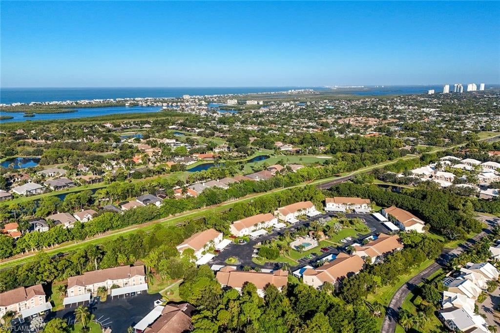 OFFERED TURNKEY! Embrace the relaxed Southwest Florida lifestyle in this inviting second-floor condo featuring 2 bedrooms plus a den, 2 bathrooms, and a charming Tommy Bahama-inspired aesthetic. Inside, vaulted ceilings and abundant natural light create a bright, airy ambiance, while tile flooring in the kitchen and baths complements the soft carpeting throughout the main living areas and bedrooms. The light and sleek kitchen features crisp white cabinetry, white appliances, and a cozy breakfast nook—the perfect spot to enjoy your morning coffee. The spacious primary suite offers a comfortable retreat with an ensuite bath featuring dual sinks and a walk-in shower. An open den provides wonderful flexibility for a home office, reading room, or guest space, with the potential to be enclosed to create a third bedroom. Step outside to the screened lanai, where a secluded wooded backdrop creates a peaceful setting to unwind, enjoy a good book, and take in the soothing sounds of nature.The location is just as appealing, with beautiful Bonita Beach and the pristine white sands of the highly desirable Barefoot Beach Preserve less than 2 miles away. Vanderbilt Beach and Wiggins Pass State Park are less than 5 miles away, putting some of Southwest Florida’s most celebrated coastal destinations within easy reach. Enjoy nearby golf, entertainment, grocery stores, shopping, an array of restaurants, and waterfront dining. With I-75 just 3.5 miles away, traveling to Fort Myers and Tampa to the north or Naples and Marco Island to the south is convenient. The community offers a centrally located swimming pool and spa, perfect for cooling off, relaxing, or socializing with neighbors, along with a serene landscape ideal for leisurely walks and bike rides. Whether you’re seeking a seasonal beachside escape or a full-time residence, this turnkey condo offers an inviting blend of tropical charm, peaceful surroundings, and convenient access to the best of the Southwest Florida beach lifestyle!