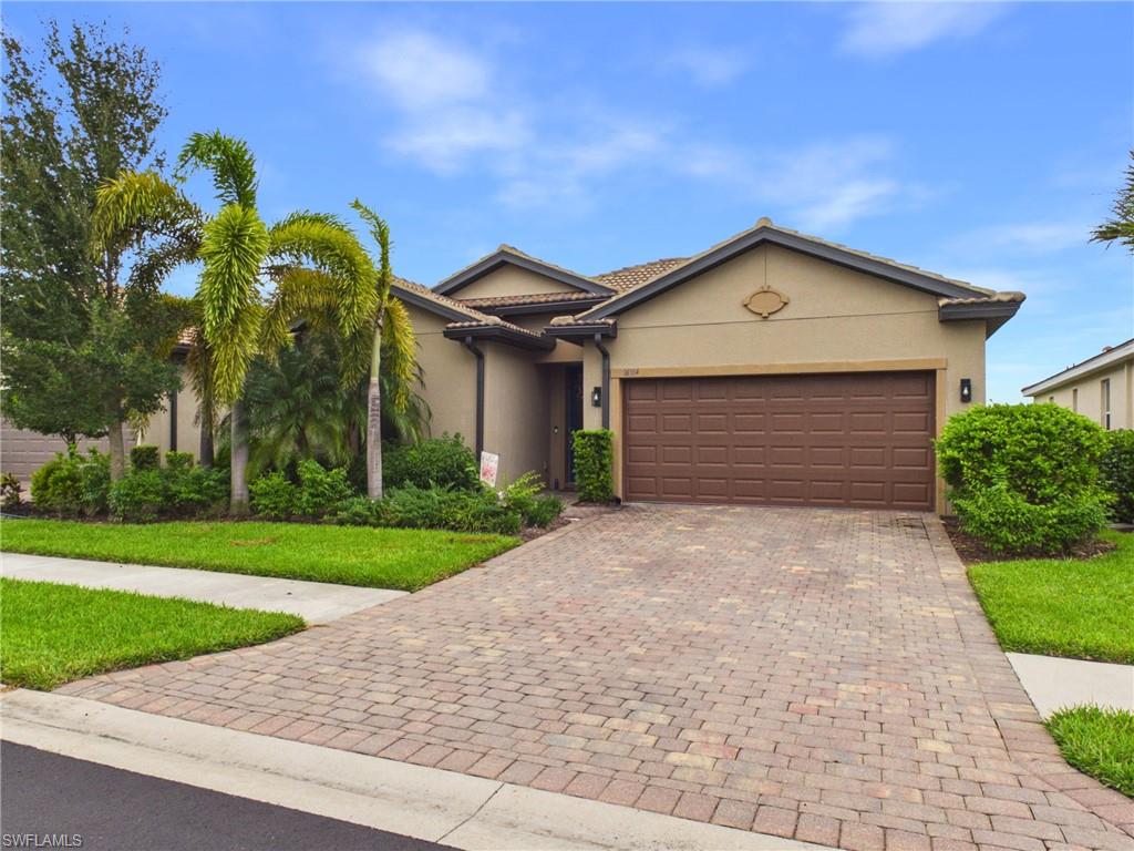 Welcome to your Southwest Florida sanctuary—where low-maintenance living meets upscale, modern design. Tucked away in the gated enclave of Hampton Lakes within Alva's premier River Hall community, this move-in-ready single-family home delivers an ideal balance of refined interior finishes and an active resort-style lifestyle.   At the heart of the residence is an expansive open-concept kitchen designed for both everyday meals and effortless entertaining. It comes fully equipped with soft-close cabinetry, a pantry, stainless steel appliances, and quartz countertops anchored by a distinctively curved center island. Large-format neutral tile flows seamlessly through the light-filled dining and living areas, which are elevated by polished lighting fixtures, recessed accents, and glass sliders opening to the outdoors. Step outside to your private, screened rear lanai with a serene view of the lake—a perfect setting for morning coffee while taking in the surrounding greenery.   The primary suite provides a peaceful personal retreat, complete with a walk-in closet and an ensuite bath finished with granite countertops. Thoughtful details continue into the garage, which features clean, professionally applied epoxy flooring. Beyond the home, enjoy access to River Hall's top-tier amenities, including a resort-style lagoon pool, fitness center, tennis and pickleball courts, scenic walking paths, and proximity to the championship golf course.